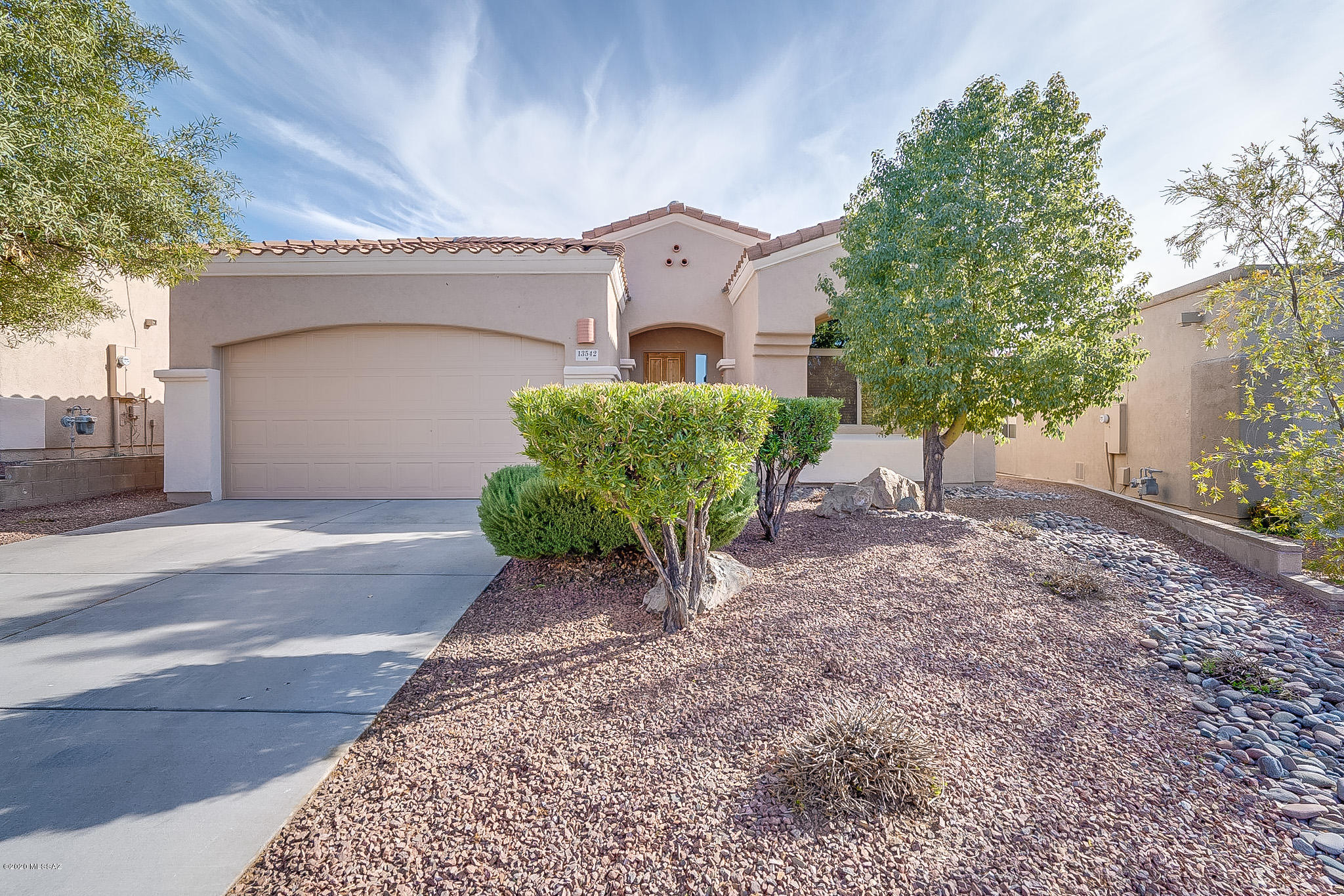 Spectacular 4 bedroom, 2 bath 1825 Sq ft home with mountain and golf course views. Tile flooring in all common areas, security system, ceiling fans, window coverings, fireplace plus upgraded cabinets throughout and cultured granite in bathrooms. Bright eat in kitchen with granite, stainless appliances, gas range, tile backsplash and pantry. Master suite has beautiful wood laminate floors, private bath with split dual vanities, garden tub and walk in closet.  Enjoy your low care back yard with patio, extended pavers, beehive fireplace and built in BBQ. Located in the Award Winning Vail School District. Easy access to shopping, I-10, Raytheon and DM.