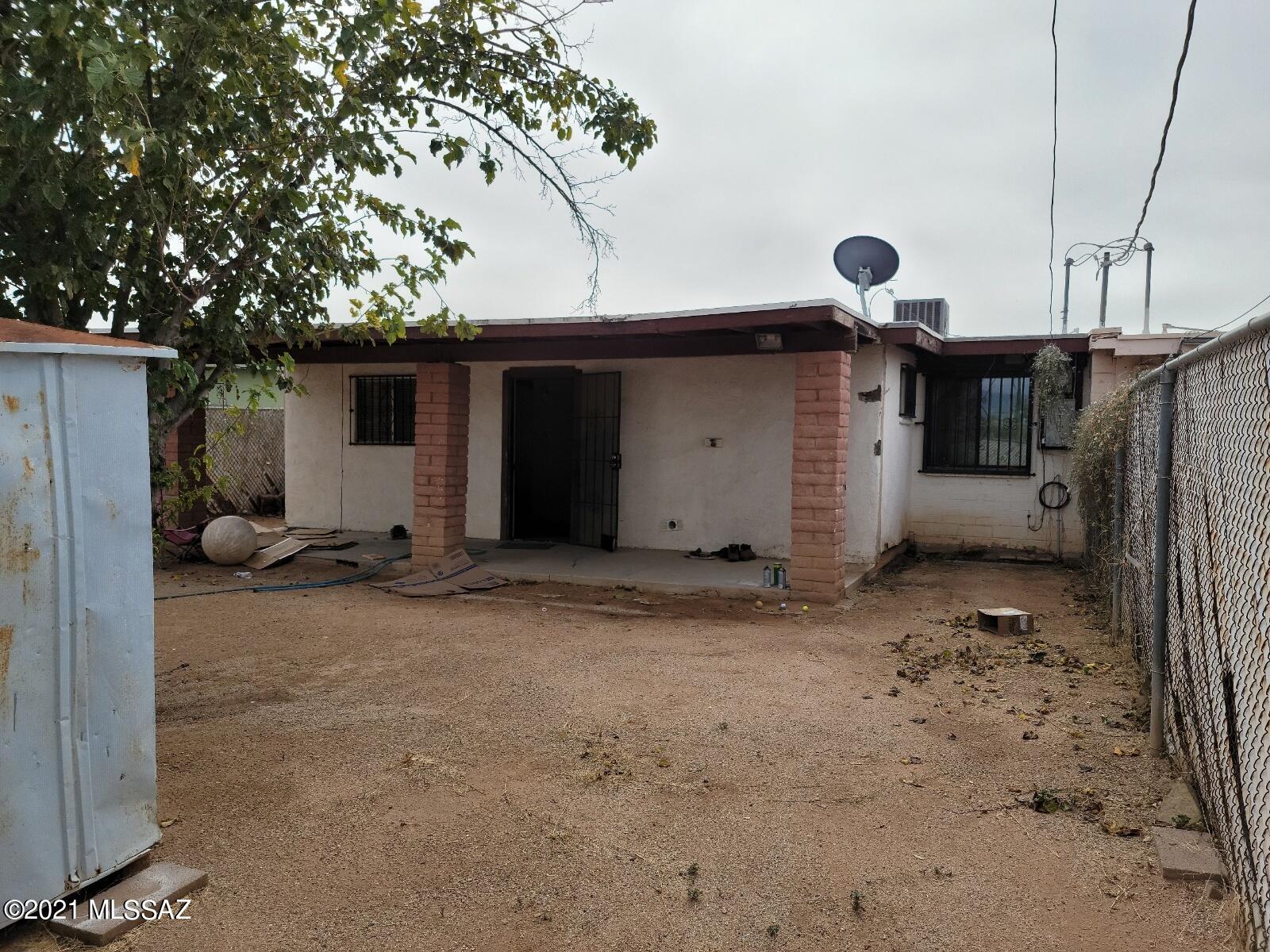 This fixup property features 3 bedrooms, 2 baths, air conditioning, a covered patio running the full width of the home, and sits on a generous sized fenced lot.