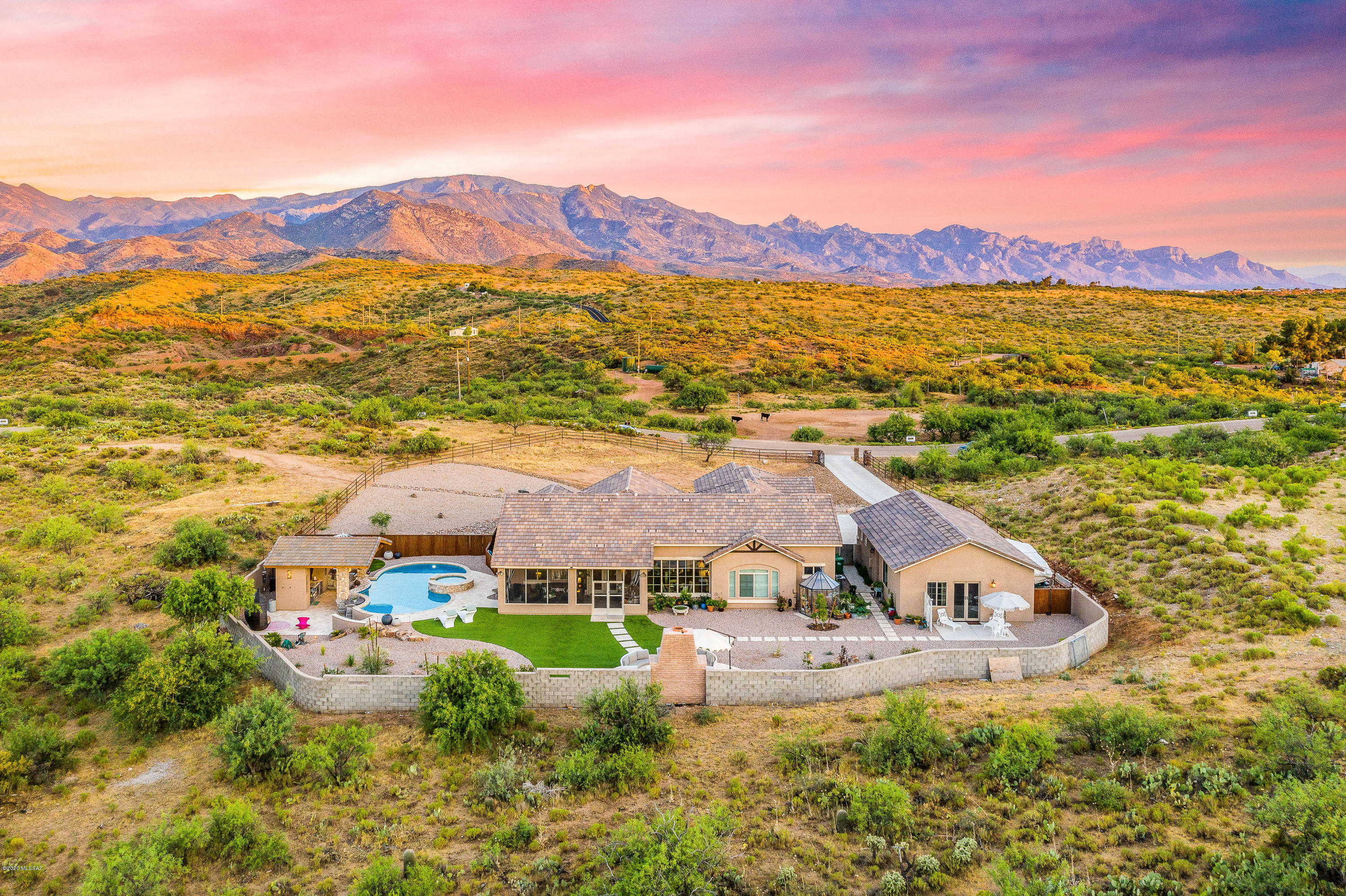 This serene sanctuary is situated on 1.28 acres bordering state land in a gated community with VIEWS in all directions. For those seeking privacy, and room to roam both inside and out, this home will not disappoint. Enter the sun-filled great room, with custom gas fireplace, 14+ ceilings and a wall of windows giving you a glimpse of the amazing grounds. The gorgeous kitchen with its maple-glazed soft close cabinets, granite counters, and double ovens are a chef's dream. The main house boasts 4 bedrooms, 3 baths, and the separate casita is perfect for guests or long-term visitors! The custom outdoor fireplace is a fabulous place to gather, adjacent to the large pool/spa with swim-up bar, cabana and outdoor kitchen. This home is SIMPLY BREATHTAKING, and located just 20 minutes north of Oro Valley at a higher elevation and cooler temps, what are you waiting for?