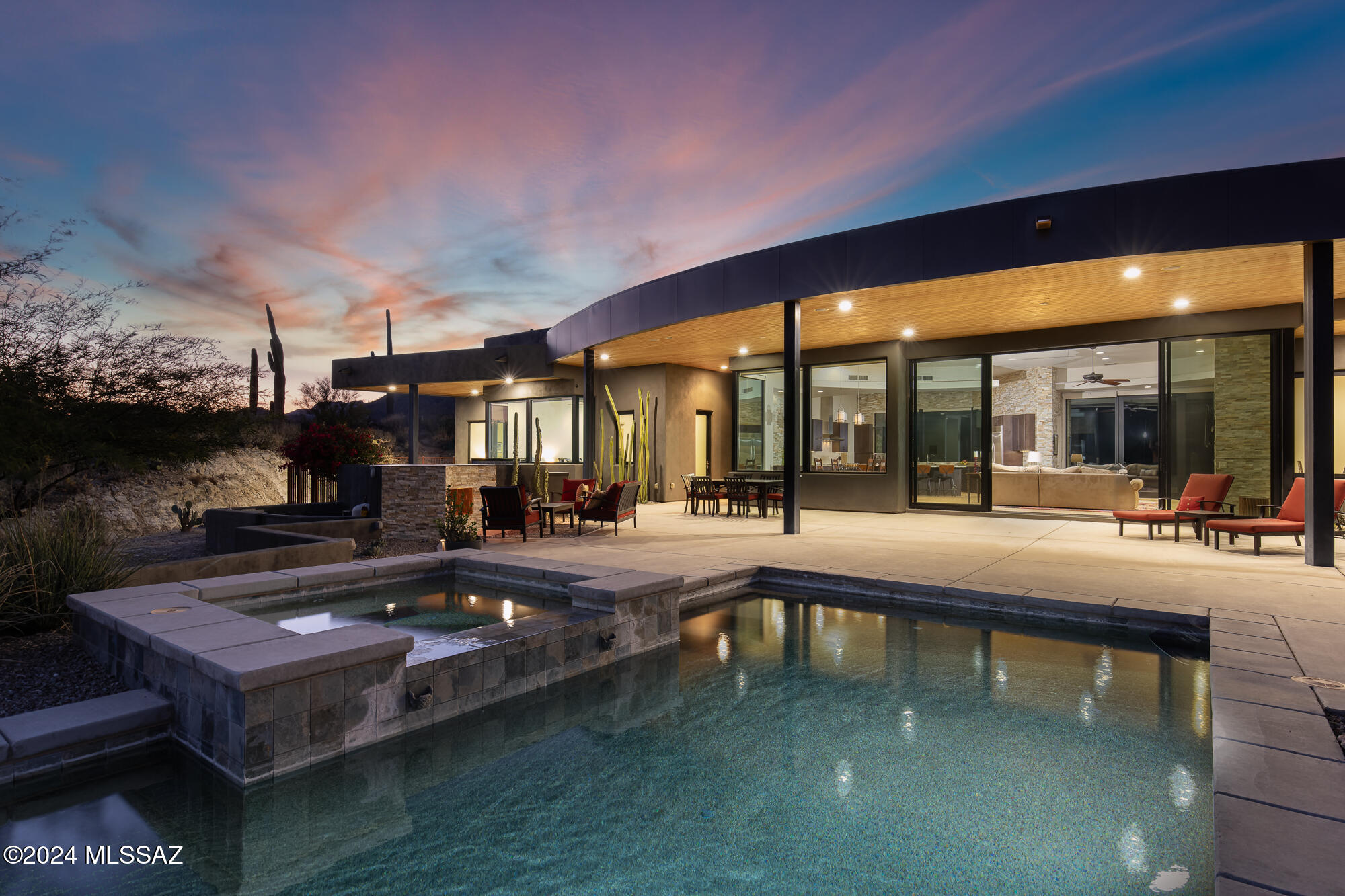 Exceptional desert contemporary custom home expertly designed by acclaimed architect Marc Soloway, situated on a peaceful one-acre cul-de-sac lot with panoramic mountain views. Located in the exclusive guard-gated community of Stone Canyon, this ultimate desert retreat epitomizes modern design and luxury living, showcasing a harmonious blend of clean lines, natural materials, and breathtaking views of the Catalina and Tortolita Mountain ranges.This one-level, 3617-square-foot residence built in 2015 features an open, easy-flowing design for function and beauty, emphasizing seamless indoor-outdoor living. The beautifully paved driveway leads to the covered entry with a pivoting glass entry door opening to the great room revealing white oak floors throughout the home.  Continued... The expansive floor-to-ceiling windows flood the space with natural light while framing captivating views of the Catalina Mountains, creating a serene backdrop for everyday living. The modern fireplace and stacked stone accents create a warm yet contemporary ambiance. The large granite island kitchen is a chef's dream, with high-end appliances and ample cabinet and counter space.
Take in breathtaking Tortolita Mountain views through the expansive north-facing window perfectly positioned above the kitchen sink.  A spacious walk-in pantry includes an additional versatile space perfect for wine storage.  The kitchen opens directly to the great room and dining area, ideal for entertaining and relaxed living. A thoughtfully designed split bedroom layout ensures privacy, with three en-suite bedrooms, a spacious den, and four bathrooms. The owner's suite is a private sanctuary with sliding glass doors open to the backyard. It features a modern stacked stone fireplace, a spa-inspired bathroom with a soaking tub, a large custom tile-surround shower, dual-sink vanity, and a spacious walk-in closet with custom built-ins. The guest wing of the home has two en-suite guest bedrooms, walk-in closets, and a powder room. Laundry room with custom cabinetry, granite countertops, a sink, and extra storage.  The great room living area opens to the resort-style backyard through retractable sliding glass doors. Enjoy Arizona living with 1650 square feet of covered patio, an outdoor fireplace, an outdoor kitchen area with a built-in BBQ, a succulent garden, pool, and spa. Full exterior paint completed Feb 2025.
Recently epoxied, oversized three-car garage with a storage closet and an EV charging station. 
Stone Canyon is set against the picturesque Tortolita Mountains in Oro Valley, just Northwest of Tucson. This private residential golf community boasts over 1,400 acres of breathtaking land, highlighted by a world-class 18-hole golf course designed by Jay Morrish. According to Golf Digest, Stone Canyon is the only golf course in the greater Tucson area ever to be ranked in America's TOP 100 golf courses. Accompanied by a luxurious health & fitness facility and modern restaurant & bar, Stone Canyon leaves no stone unturned in providing you with all the comforts one could desire. 
The newly designed Clubhouse opened in 2016. The 25,000-square-foot complex features a men's and women's locker room, golf shop, dining room, indoor bar, outdoor bar with a fire pit, and ample outdoor covered seating. With 270-degree views, the clubhouse provides the perfect setting for enjoying a cocktail or a meal with friends and family.  Visit stonecanyon.com for more information about the club amenities, pickleball, and a full list of group exercise classes, including yoga, pilates, barre, HIIT, and more.
Oro Valley is about 3 miles north of Tucson city limits and is at an elevation of 2,620 feet. This 35-square-mile town is between the Catalina and Tortolita mountain ranges, providing dramatic views and wide open spaces. Community events include Saturday farmers markets, year-round live concerts, art festivals, car shows, heritage events, cultural tours, and holiday celebrations. Oro Valley is a year-round outdoor sports mecca for walkers, runners, hikers, cyclists, mountain bikers, or horseback riders who can enjoy 60 miles of shared-use paths throughout the town. Oro Valley is the gateway to the Catalina State Park. It even connects to the 130-mile connected path, the Chuck Huckleberry Loop, named USA Today's "Best Recreational Trail" in America in 2021 and 2022. Mount Lemmon, where locals go to escape the heat in the summer and ski the slopes in the winter, is 60 minutes away. 
Stone Canyon is convenient to a long list of unique local restaurants, large and small retail shopping, a movie theatre, and the Oro Valley Hospital.