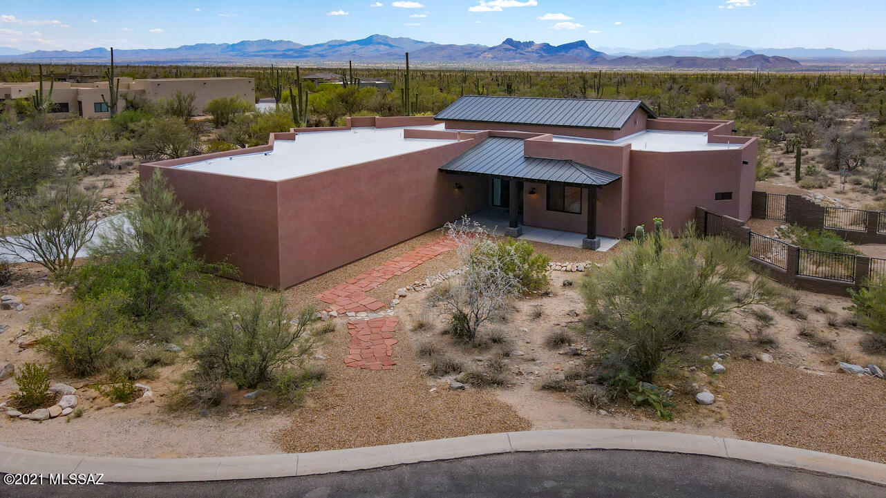 Custom, John Herder home blending contemporary & rustic styling to create a tranquil space within the small, gated community of The Estates at Tortolita Preserve. Sits on a private, seemingly endless, 2.5 acre lot with stunning mountain & desert vistas. Built in 2019 and gently lived in, the home features split bedroom plan (one ideal for office), 3 full baths plus powder room. Gorgeous granite countertops in chef's kitchen with Bertazzoni appliances plus 7' island with prep sink. Richly-hued solid Alder doors throughout. Vaulted great room ceiling and 8' wall of sliders to bring the outside beauty in.  Oversized garage for all the toys. Location is ideal for those seeking an active lifestyle with nearby biking/hiking trails, off road vehicle access and exceptional golf.