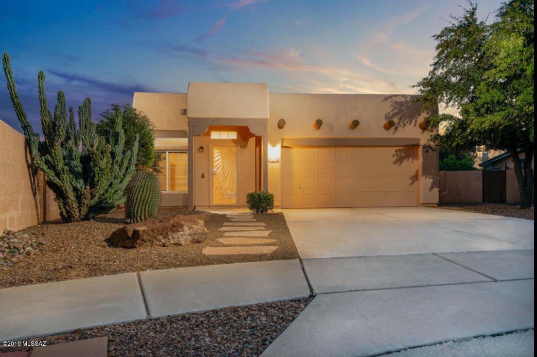 Investor special or future Oro Valley resident who wants to secure their house now / move in later. Property has existing lease thru Oct 2020. Fantastic four bedroom, two bathroom home built for comfort and entertaining. Formal living and dining upon entry with built in custom dry bar with wine refrigerator and fireplace. Enjoy spacious family room / kitchen which offers a full length breakfast bar, plenty of cabinet space, and tasteful backsplash. Master bath features oversize shower and large soaking garden tub! Nicely landscaped backyard with pavers and real grass. The garage features custom storage. Best part no poly pipes! Pex piping. You do not want to miss this opportunity.