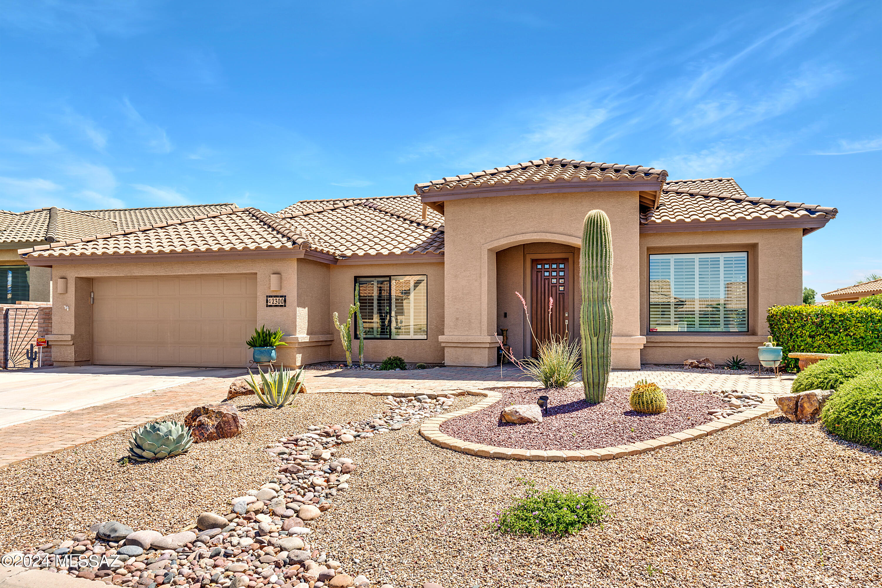 Ideal for entertaining, come see this impeccably maintained 3 BR 2.5 BA home in gated Quail Creek resort community. This Cheyenne model offers both formal and informal living and dining spaces. The spacious chef's kitchen has center island and breakfast bar, granite counters, an abundance of cabinets, including 41 uppers, under-cabinet lighting, desk and casual dining nook. The adjacent family room has a gas fireplace, large flat screen tv (included) and a wet bar. The expanded Owner's Suite in soft, calming colors has a bay window, dual vanity bath, soaking tub, separate shower, and 2 walk-in closets. The split bedroom plan offers privacy for guests, offering 2 guest rooms, or use one as an optional Den, and a guest bath. Plus there's a powder room adjacent the large laundry room, which offers tons of extra storage. Don't miss the bonus, air conditioned hobby room accessed from the garage (which could easily be converted to golf cart space). Plantation shutters throughout. Wonderful outdoor space on a large .23 acre lot offering a covered patio, mountain views, lush yard, and water feature. New roof 2019.
