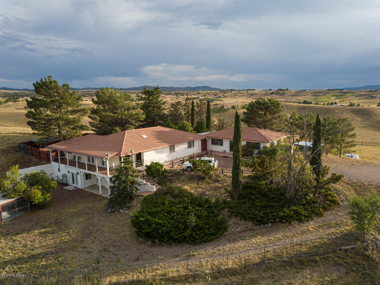 The best of Sonoita's rolling grasslands! This sensational hilltop custom built 4/Bed 3/Ba has private gated entry and panoramic views of all ranges in the Mountain Empire! Spacious floorplan great for entertaining. Newly installed elegant wood look ceramic floor tile. Kitchen features gorgeous granite countertops, built in desk, SS appliances include smooth top range, dishwasher and French door refrigerator. Large Master Suite opens to lush courtyard. Enjoy the sparkling pool in the separate pool house or relax on one of the surrounding porches. 4 stall barn and shaded dog runs. Near the heart of Arizona wine country, lakes, ride out, national forest and easy commute to Tucson or Sierra Vista. Soak in the majestic scenery where the deer and the antelope play! Come visit this must see home