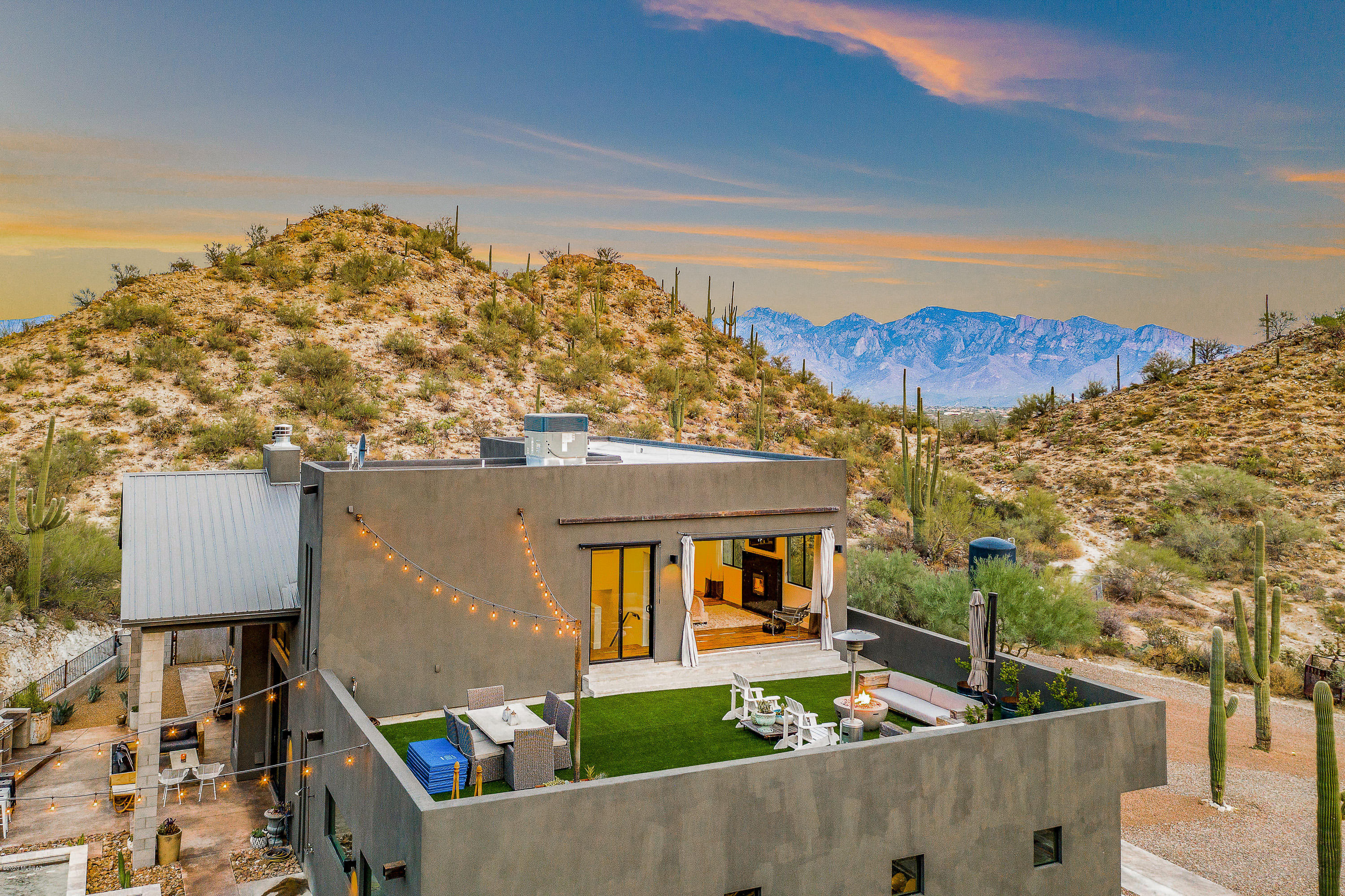 One of kind! This unique new build is tucked away in the Tortolita mountains and overlooks hundreds of saguaros, as well as city lights after nightfall. A beautiful balance of modern and rustic design, this home has the latest technology coupled with an 
antique finished teak door and flooring from India.  High ceilings, and large windows each room is light-filled and spacious. Large kitchen with stainless appliances, custom concrete countertops, Carrara marble backsplash and so much more! Oversized 1000 sq ft  garage, custom pool, outdoor fire place, and a rooftop deck. This home has everything needed for indoor/outdoor entertainment. AMAZING WELL with 27 GPM production on last test. Three bedrooms, two and a half bath -each unique in design. A truly stunning property.