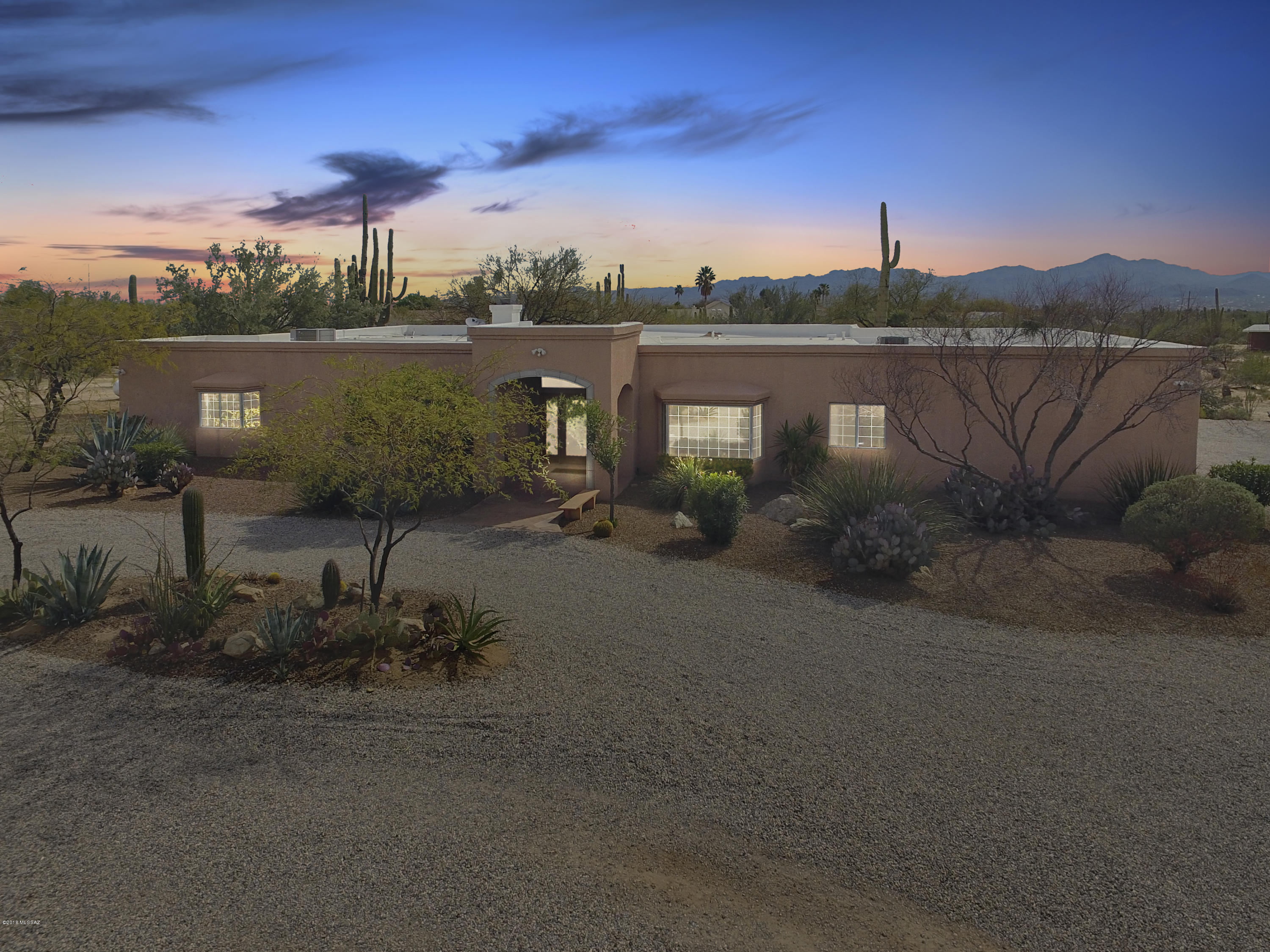 PRIVATE. DESERT. RETREAT. Arrive through your private gated driveway. Beautiful natural desert landscape welcomes you along the way for a hint of what's to come on 9.55 acres. Expansive custom adobe home with covered entry greets you. Natural light floods in glass entry doors and large windows. Thoughtful floor plan boasts huge master bedroom, two guest rooms with attached bath, office and additional guest bath.  Plenty of room for family & multi-generational living!!! Resort-like pool with waterfall. Walled yard with panoramic mountain views and covered patio are perfect to entertain year-round. Additional property features include separate guest house with detached carport, 10 car detached garage/workshop/storage. Buyer to verify all facts & figures, including those listed in the MLS. The colorful 572 SF adobe guest house will inspire creativity. Set back from the main residence enjoy privacy and seclusion. Custom metal yard enclosure keeps pets safe while you indulge in painting, crafts, yoga or meditation while taking in the fresh air, desert landscape, wildlife and views.  Guest house with detached 2 car carport is perfect for an art studio, guests, vacation or income rental. 

With 9.55 acres of private land the property has plenty of room for horse facilities, see aerial photo showing historical horse use/facilities.

While the main residence has an attached 3 car garage with storage room, the property also includes a huge detached 10 car garage with 3 roll-up doors is perfect for your personal car collection, toys, storage or workshop. An additional 2 car carport and covered RV parking with water and power hookups at the end of the building. 

67.8 acres of Pima County DOT Mitigation Land, a wildlife preserve for pygmy owls, borders the property to the west along Linda Vista Blvd & Camino de Oeste. 

Your private 9.55 acre desert oasis is minutes away from shopping, golf, convenient access to I-10 and 35 minutes to Tucson International Airport.