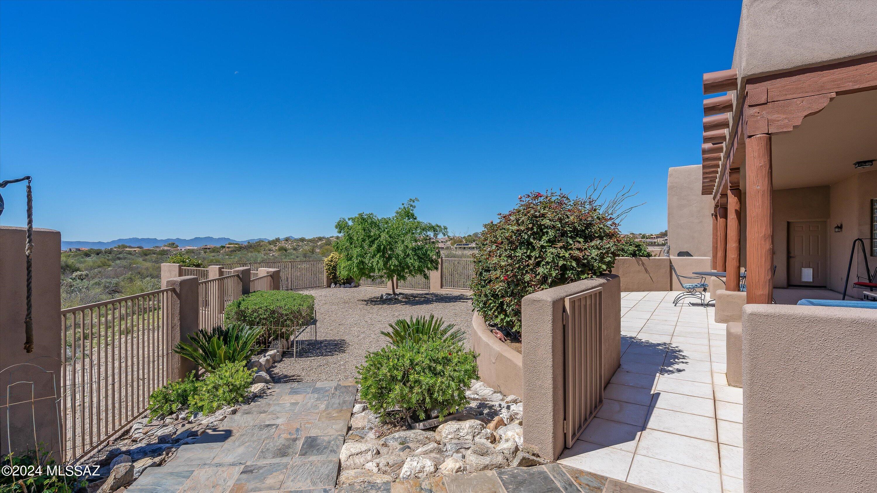 The Best Buy in Oro Valley!! Desert luxury in this spacious 3437 sq ft home featuring 5 BR's & 3 Baths on a private 1.82 acre pool-sized lot, surrounded by over 103 acres of pristine common area and county riparian area. Chef's Kitchen with massive island, double ovens, sep cooktop & custom pantry. Grand Great Room, double-sided fireplace, formal dining and views from every window. Unwind in the Primary Suite w /FP, private patio, En-Suite Bath with executive, dual vanity, oversized walk-in shower & jetted tub. Expansive Covered Patio is the perfect setting for dining & entertaining. Hot tub beckons you to enjoy mt views and starlit skies. Rolling shutters on all windows, soaring ceilings, all closets are custom, fire sprinkler system, extended 3-car garage with workshop & evap cooling.
