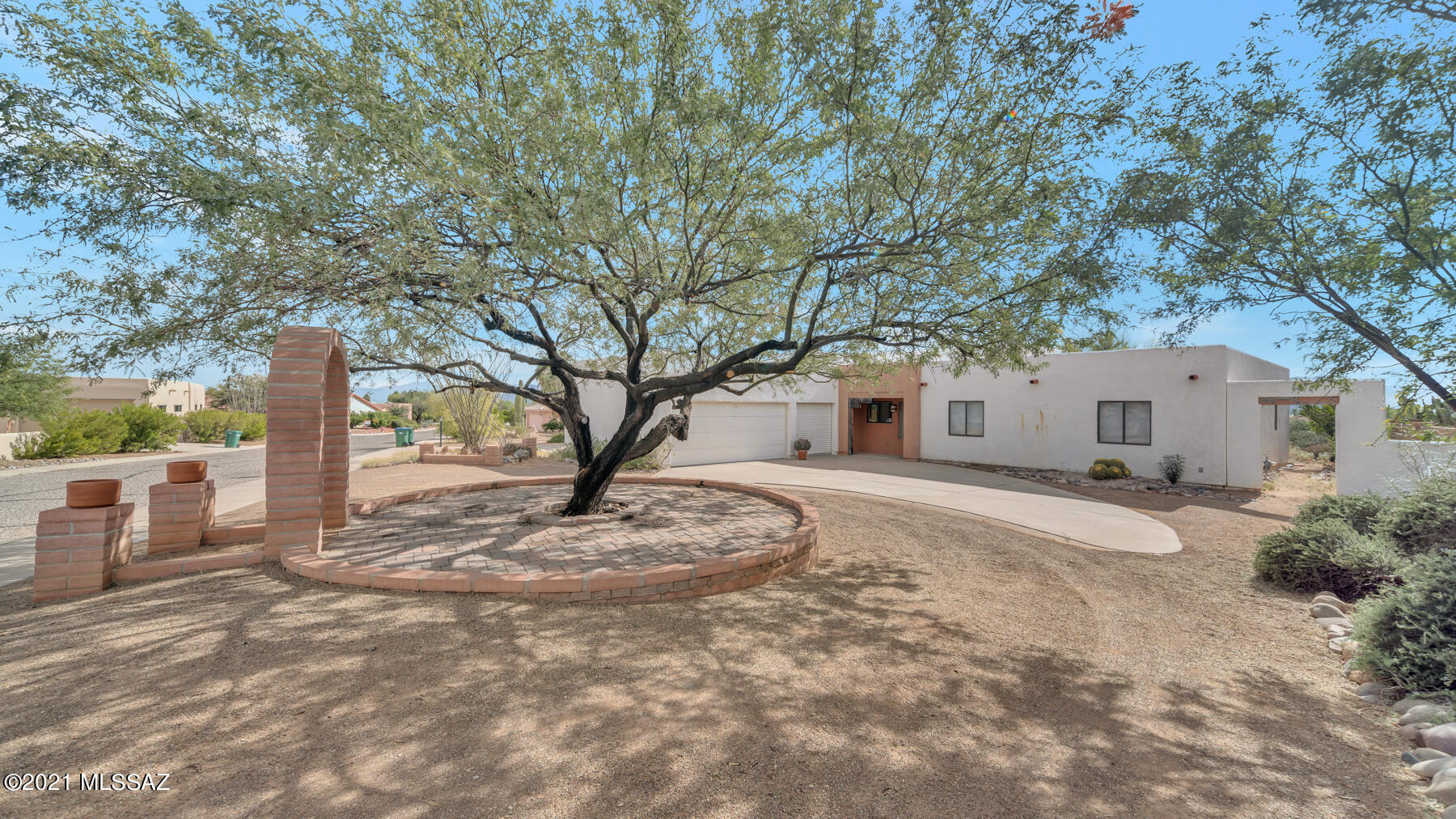 Location Location!!  In a highly desired neighborhood, this house has the wow factor with the stunning mountain views!  You can change the house but can't change the view.  As you pull up to the circular driveway you are greeted with a majestic shade tree and a charming arched entry.  The backyard is open to the desert which allows you to enjoy all the fun wildlife.  Pull up a couple bar stools at the raised bar outside and enjoy the sunset as it dances colors across the marvelous Santa Ritas! It doesn't stop there. You get to bring the outside in, with views from nearly every room. The garage has a glorious bonus room that can be used as storage or you can easily convert it to a man cave or she shed since it is setup to install a sink and toilet. Needs major repair work and its ''AS IS''
