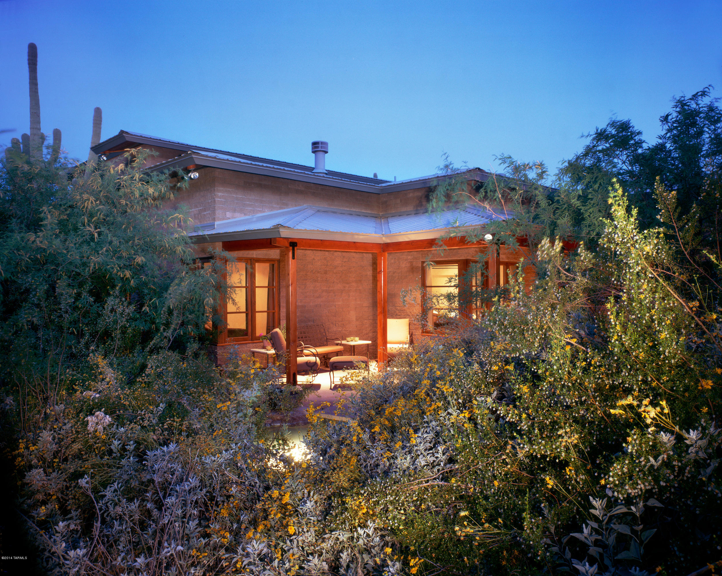 The home has been described as “an 1800’s ranch house brought forward”.  Masterfully designed by Frank Mascia with a Frank Lloyd Wright feel.  Laid out on a 3.3 acre lot w/5 covered patios, wonderful views of the mountains and desert, an add’l patio juts out to overlook the Agua Caliente Creek under a 40 ft mesquite!  The home features finishes you’d expect with this level of attention to detail – imperial plaster, raked joint masonry walls, travertine, scored concrete floors, custom mesquite cabinets, granite counters and tall ceilings, plus expansive master suite, chef’s kitchen, heated/cooled 4 car garage w/ workshop & bathroom (could be made into a guest house) plus an add’l 2-car garage.  The oversized windows capture the wide variety of foliage, from mesquite to sagua