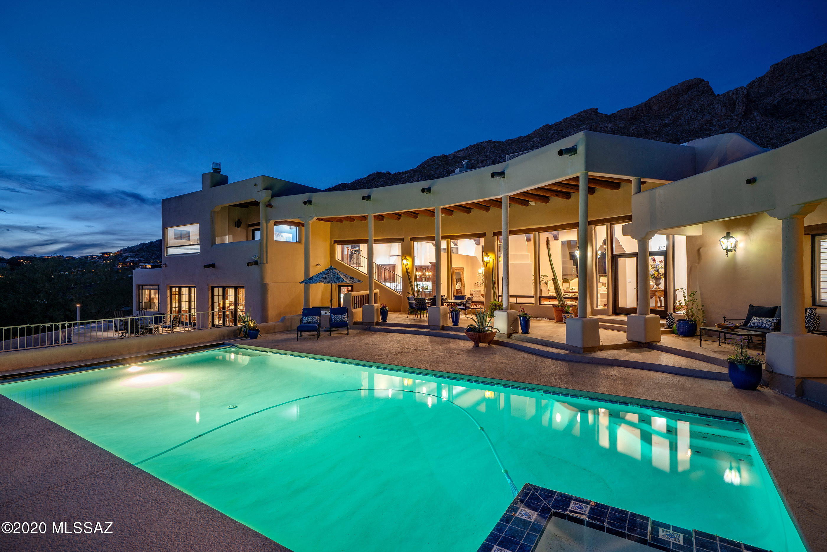 Enjoy some of the most dramatic Catalina Mountain and expansive city views stretching out over the valley below, from this privately situated residence. This thoughtfully crafted and timeless estate home, features classic detailing with a modern ease and intimate luxury.  
Upon arrival, an air of grandeur pervades this incomparable residence, privately located at the base of the Catalina Mountains and surrounded by sprawling mature desert landscape, adding to the feel of the sophisticated estate. Entering the home, you are greeted by a large foyer with soaring ceilings, acting as the central hall, establishing the main connection point of the home, which opens onto the formal living and dining rooms, with scaled picture windows strategically placed to enhance the many view corridors... Complementing this perfectly executed floor plan, are lofty ceilings and doors that open onto the tranquil grounds at every turn. The heart of the home is the fabulous reimagined chef's kitchen featuring top end fit and finish, which includes a large center-island, granite countertops, ample storage and a Pro Series Decor appliance package. 

The lower level family living room is designed to substantial scale and comfort, allowing versatility in its use to reflect the activities enjoyed by its owner and includes a hand crafted credenza with built in wine refrigeration, exuding elegance with carved wood cabinetry and granite countertops.

Located on the upper level of the residence is the sumptuously appointed owners suite, with a custom walk-in dressing room, luxuriously finished spa-like bath, office/workout flex space, with a walk-out covered balcony, perfect for enjoying the breathtaking mountain views. The balance of three bedrooms are sequestered on the East wing of the residence, each with direct access to an adjoining bathroom, perfect for families and guests alike. 

An elongated veranda connects the shared living spaces, with a series of doors coordinated to tie the interior rooms to the spacious outdoor living environments, resulting in a juxtaposition of private and social spaces. Layers of elevated patios, with various native shrubs cause an explosion of color, light and shadow, creating a framework for the pool, acting as the centerpiece of the rear courtyard. 

Seamless indoor-outdoor entertaining while out on the sun-drenched South facing terrace, offers al fresco dining, with a dedicated built in barbecue station, a putting green with customized green speeds, breaks, fringe and rough, creating the ideal practice surface, with unobstructed Catalina Mountain and city views beyond.