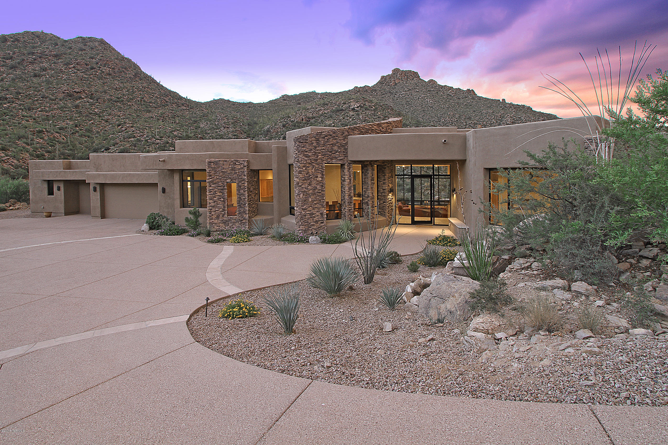 Stunning Contemporary nestled high in spectacular guard gated Canyon Pass offers sweeping Tortolita views. Grand entrance w/rock waterfall leads to a  Great Room w/fireplace and wet bar, formal Dining Room, Office/Media Room/5th Bdrm, plus large state-of-the-art Kitchen w/Alder cabinets, granite counters, island, breakfast bar & nook. Master Suite hosts a fireplace, his/hers closets/vanities, and circular Jacuzzi tub. Travertine tile featured throughout plus architectural details such as grand view windows, archways, rounded walls, cove ceilings, art niches, and stacked stone outdoor pillars. Four bedrooms feature en suites; one w/pool access. Enjoy the outdoors year round while relaxing on a spacious patio featuring negative edge pool w/raised spa, fireplace, grill and breathtaking views!