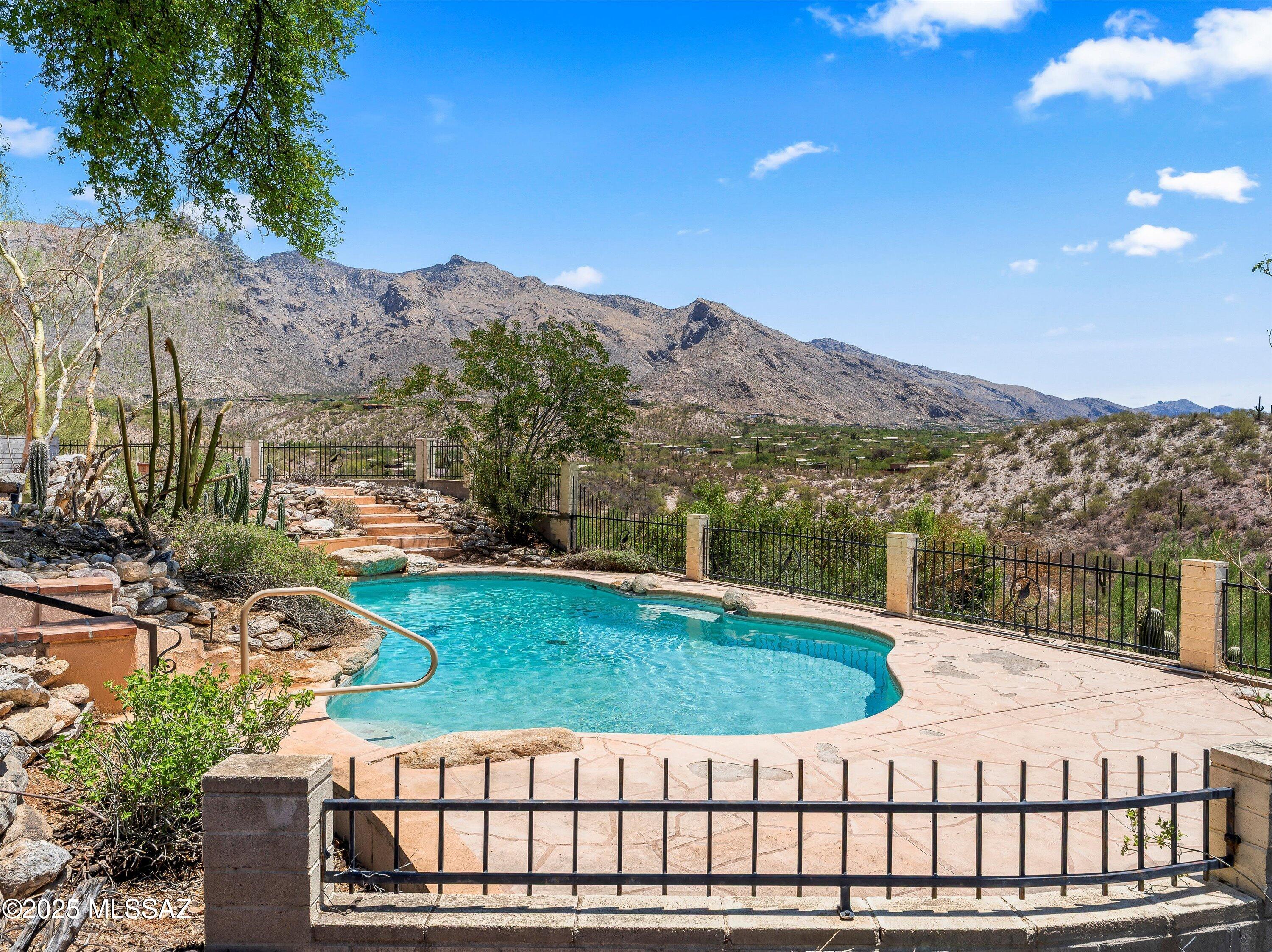 Discover an incredible opportunity to own a piece of paradise in the prestigious Foothills neighborhood, one of Tucson's most coveted addresses. This single-story home sits majestically on an elevated hillside lot in the Catalina Foothills, offering absolutely breathtaking east-facing views of the dramatic Catalina Mountains that will stop you in your tracks. Located within the Catalina Foothills School District and within walking distance to Manzanita Elementary School, this property represents the perfect combination of prime location and stunning natural beauty that defines luxury desert living.
The thoughtfully designed 4-bedroom, 2.5-bathroom residence showcases an impressive layout featuring a welcoming living room with dramatic stone fireplace, spacious family room, formal dining area, and convenient breakfast bar that flows seamlessly throughout the home. The primary bedroom offers direct access to the spectacular Arizona room with its wall of windows that frames the magnificent mountain vistas while creating the perfect space for year-round enjoyment of Arizona's incredible climate.
The crown jewel of this property is undoubtedly the backyard oasis, where a sparkling pool takes center stage against the most spectacular mountain backdrop imaginable. The elevated positioning ensures complete privacy while maximizing the stunning desert panoramas that stretch endlessly toward the horizon. These are the views that make the Catalina Foothills legendary - dramatic mountain silhouettes, endless desert vistas dotted with saguaro cacti, and sunrises that paint the sky in brilliant colors every morning.
With immediate access to nearby trails for hiking, and mountain biking, outdoor enthusiasts will find endless adventures right at their doorstep. Yet despite this serene mountain setting, you're just minutes from the sophisticated amenities of La Encantada's shopping and dining, the charming boutiques and galleries of St. Philip's Plaza, and the renowned restaurants and art galleries that make the Foothills a cultural destination. This rare balance of wilderness tranquility and urban convenience creates an unparalleled lifestyle experience.
Beyond these incredible lifestyle advantages, this exceptional property represents a unique opportunity to create your dream home in one of Arizona's most desirable addresses. With excellent bones, versatile living spaces, and endless potential for customization, the home offers the perfect foundation for transformation. The combination of prime Foothills neighborhood location, world-class views, school district access, outdoor recreation, and sophisticated nearby amenities makes this a truly special offering. When location and views are this extraordinary, the possibilities are limitless - these are the mountain views that dreams are made of in the heart of the Catalina Foothills.

Priced to sell - contact Oliver Realty today to schedule your private tour of this remarkable home!