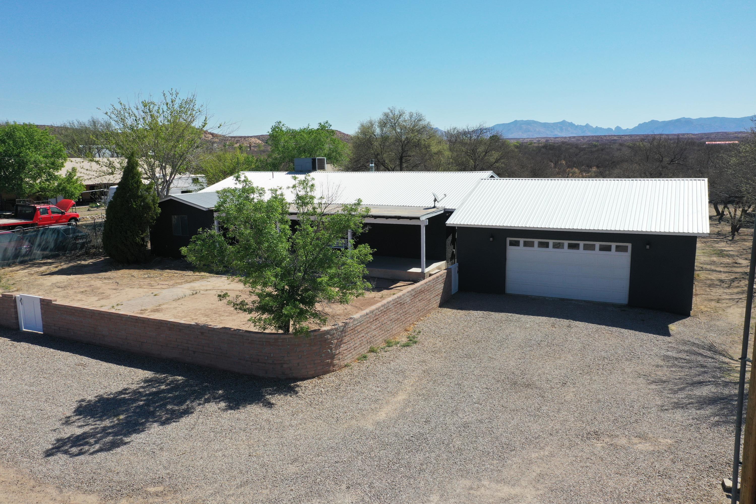 Freshly remodeled home on 1 acre! Large 4 bedroom, 2 bathroom home with a metal roof, new water proof laminate flooring flows throughout the home, fresh paint, new fixtures. Both bathrooms have been completely redone with new vanities, new flooring, fixtures  and a tile shower! The kitchen has new countertops, new stainless steel appliances and a massive walk-in pantry! The property has an oversized 30x30 garage, horse stalls, mature trees  and an additional workshop.  Property is not located in a flood zone!