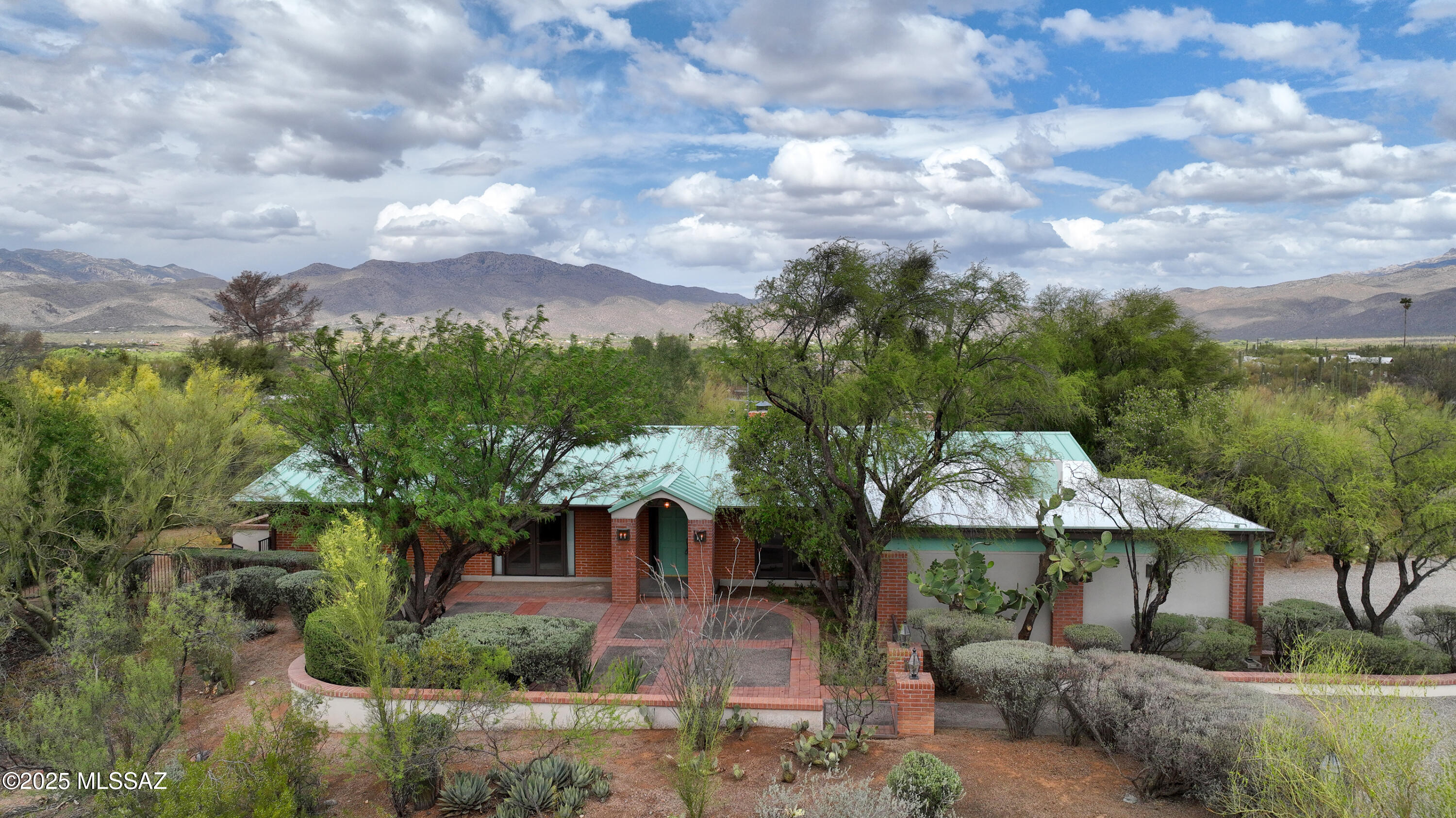 Beautiful eastside 4.3 acre horse property with views of Catalinas and Rincons. Saguaro studded lush desert landscaping giving you privacy & endless wildlife entertainment. House boasts 2649 sq ft 3 bed 2 bath. Modern kitchen, 2024 appliances, granite counter tops, open to family room. large formal dining room. Cooled wine closet. 2 Fireplaces. Zoned HVAC aprox. 2015. Split bedroom floor plan. Primary suite opens to private courtyard & Spa. Primary bath is a suite in its own right with 3 walls of closet space, walk-in shower plus a soaking tub with views of stunning saguaros. Don't forget to bring your horses-Tack room, arena, two stalls and cover for your hay. Two car attached garage with lots of storage. Metal roof on main house renewed May 2025. Garage roof recoated too. A must see hom