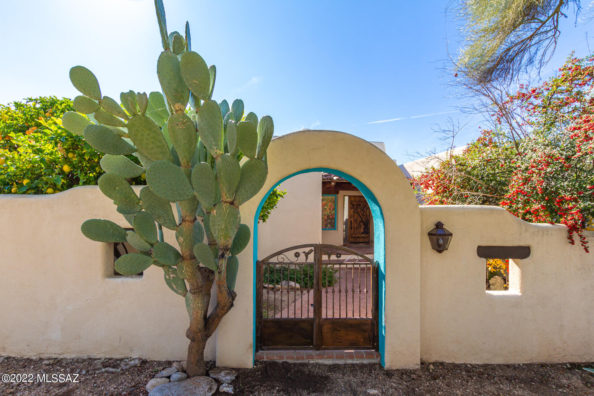Fabulous Santa Fe home situated on a corner lot needing TLC. Boundless character & charm offer the essence of a Southwestern lifestyle.  With updating & repairs you will have a one of a kind home in the Catalina Foothills.  Reseal the Mexican tile or make your own changes.  Appreciate the Pecky Cedar ceilings/Viga Beams, high ceilings, large windows and 3 french door exits.  Arched entries into light and spacious rooms. Enjoy amazing mtn views from the kitchen window & breakfast nk.  3 beehive fp's, 4 brs, & 3 1/2 ba.  The back yard is a blank slate for your imagination.  Keep the lush desert vegetation & create a desert oasis. The enclosed front courtyard makes a quiet and private retreat for enjoying beautiful desert mornings. Home to be sold as is. Roof recoated 10/22.  Pella windows on some N facing windows.Two fireplaces don't work.  Http and 1 water heater replaced 2022.  Roof recoated 11/22, Termite treatment 11/22.