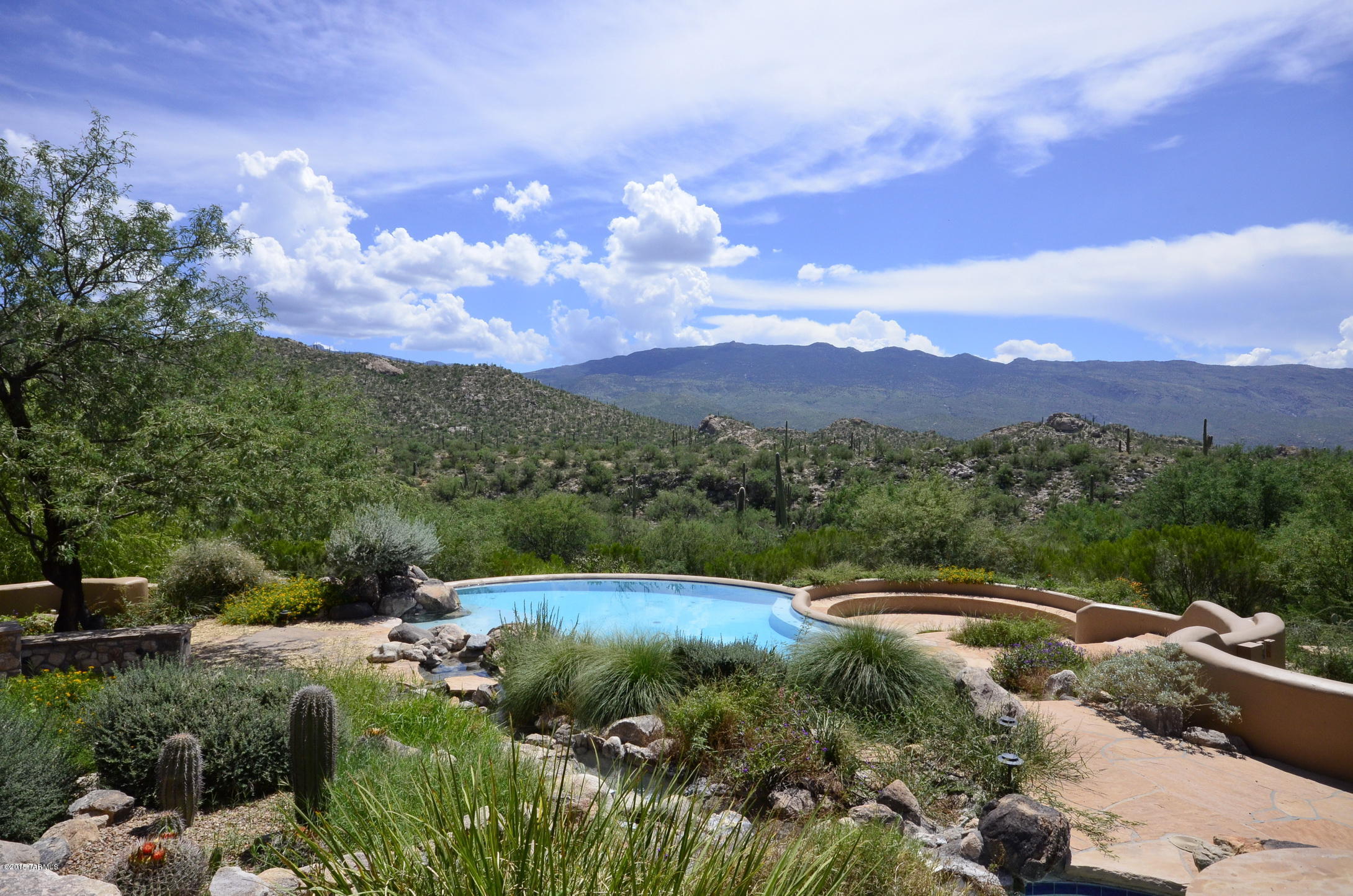 Catalina Foothills with Saguaro Studded Views 
Most Impressive Estate with it's own water well. I have never seen so many Saguaros on one property that sets off the views like fireworks on the forth of July. This is an exciting property to see and maybe someday call your own. Once you drive through the gated entry and follow the driveway to the top of the property you know that you have arrived at that special place.  Nestled on almost 40 secluded acres with incredible mountain and desert views. This Santa Fe Estate features 6 fireplaces,6 garage spaces, 6 bedrooms and an amazing outdoor kitchen. Relax and enjoy the views, wait for the deer to visit while you soak in the hot tub and gaze at the stars. Guest house features 2 bedrooms and a champagne soaking tub, fireplace and full kitchen.