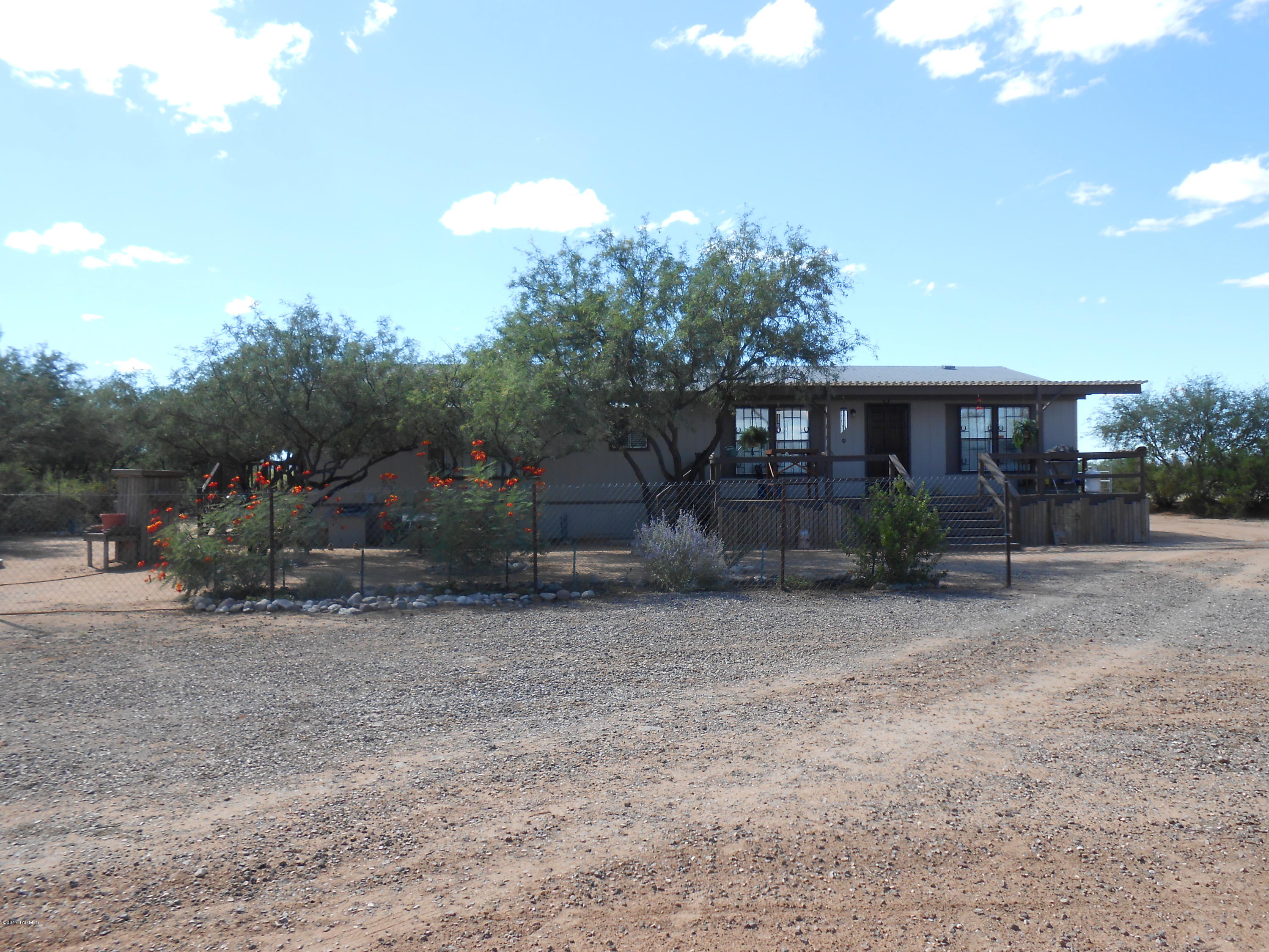 Super nice home on over 4 acres! Bring your horses, ATVs, and RV! Home is a year 2000 (28' x 58') with 3 bedrooms and 2 full baths. Features a spacious eat-in kitchen with island, open floor plan, fireplace, central AC, a large workshop, and a huge covered RV parking. Front and back patios are covered. This won't last long and is a MUST SEE!