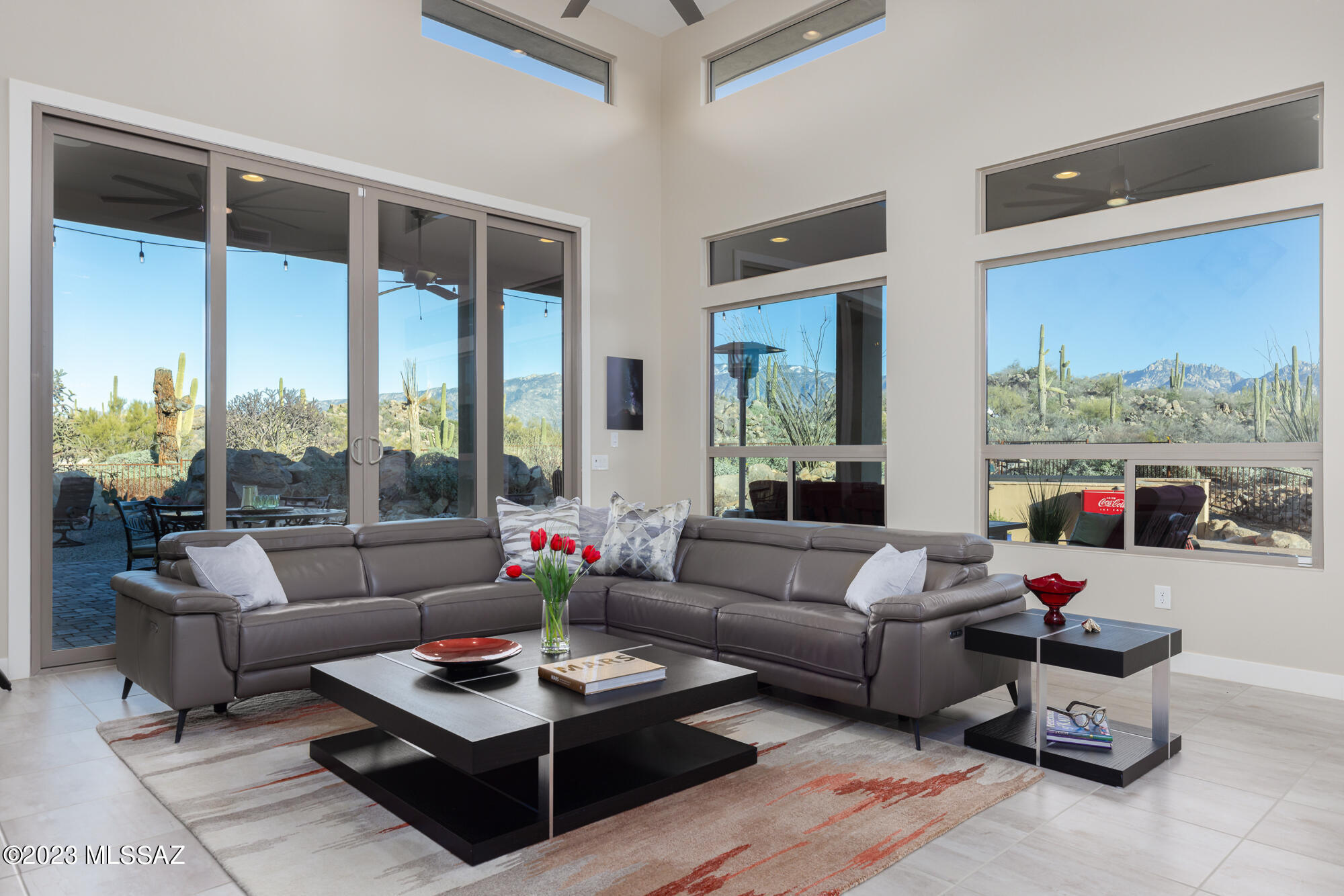 VIEWS! Marvelous 2,751 SF contemporary with open great room ''Nicklaus'' floor plan in guard-gated Stone Canyon's Boulder Vista community. High ceilings and windows create a bright retreat with PANORAMIC VIEWS of the Catalina Mountains. Inviting gated courtyard with sitting area to enjoy AZ's famed sunsets. Formal entry leads to 2 guest suites, powder room, laundry room, 3-car garage (finished floor & HVAC), lovely den/office, and spacious great room with built-in bar, spacious dining area, luxury kitchen with walk-in pantry & delightful open living area with marvelous Catalina views. Private yard with covered L-shaped patio and rolling sun screens includes hot tub perfect for stargazing! Master suite offers views, bath with large shower, dual vanities & spacious closet. PERFECT AZ RETREAT