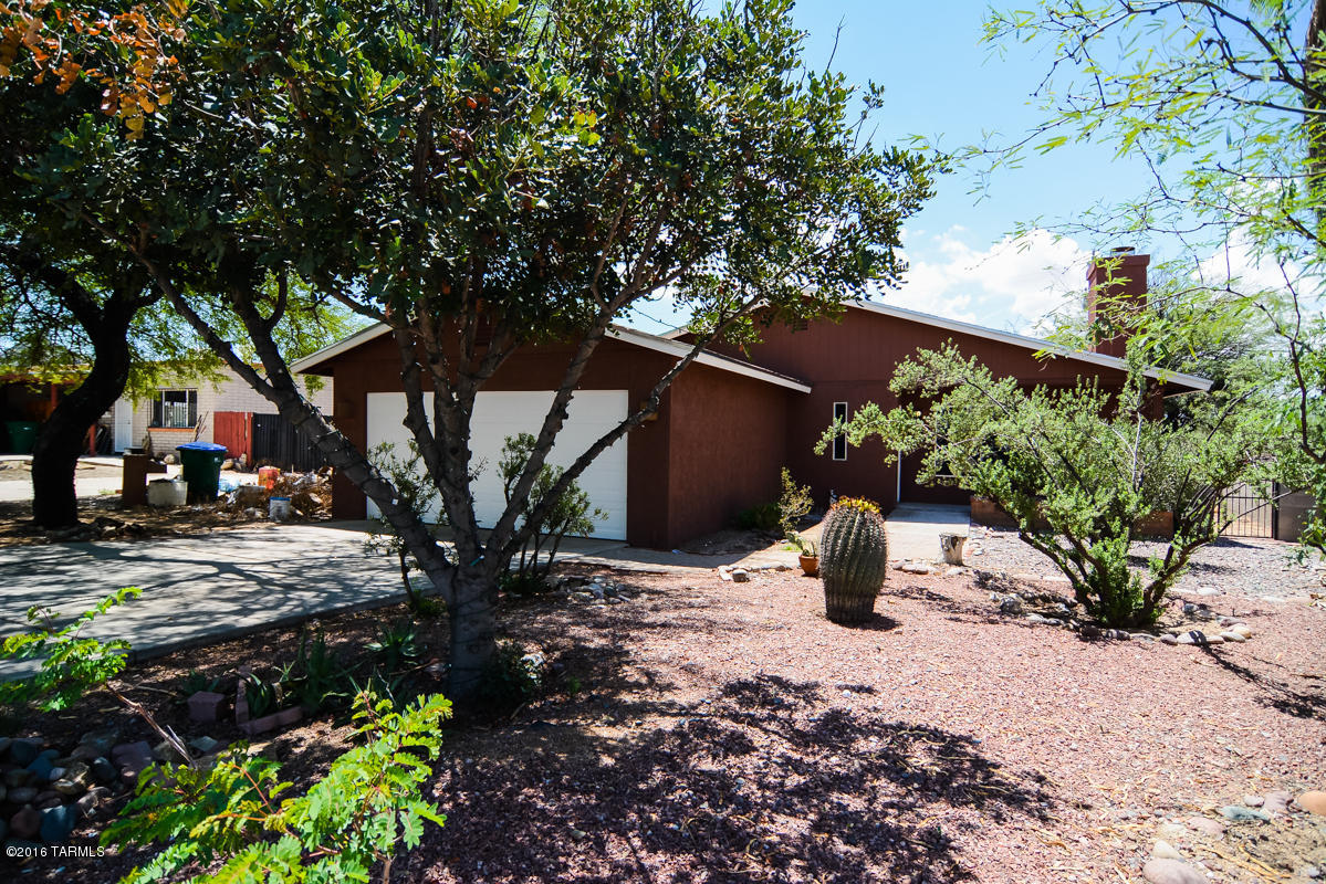 Sophisticated contemporary remodeled home. Located in a highly desirable South Tucson subdivision. Dark wood flooring. All new kitchen offers granite counters, SS appliances & gorgeous modern cabinetry. Custom rich earth tone interior paint. Tile accented fireplace. Updated bathrooms. Large master bedroom and bathroom. This home has been meticulously updated with new hardware and light fixtures.  Two car garage. Come & experience the charm & warmth this home has to offer