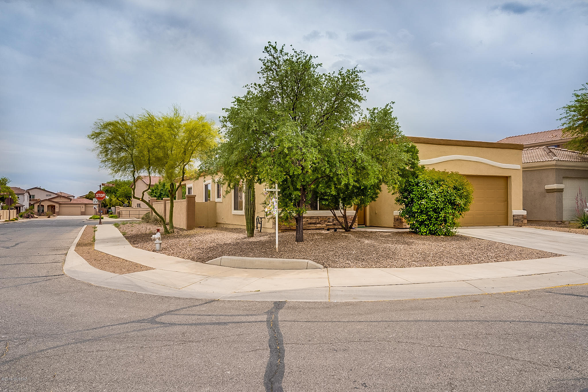 This single story Rancho Sahuarita home for sale has plenty of room for the whole family with 4 bedrooms & 2 baths. Living room with dining area is separated by an archway from kitchen with another dining area, breakfast bar on the island, & a family room. Master suite is located at the rear of the home. Pass-through style hall bath separates one bedroom near master from two more bedrooms near the front of the home. Covered patio faces south, no rear neighbor, only one side neighbor as this is a corner lot. Short walk to park with community ball-fields, soccer fields, skate park, playground. Close to clubhouse with water park, full gym, & more. Short drive to shopping, banking, restaurants, & easy freeway access for the commuter.