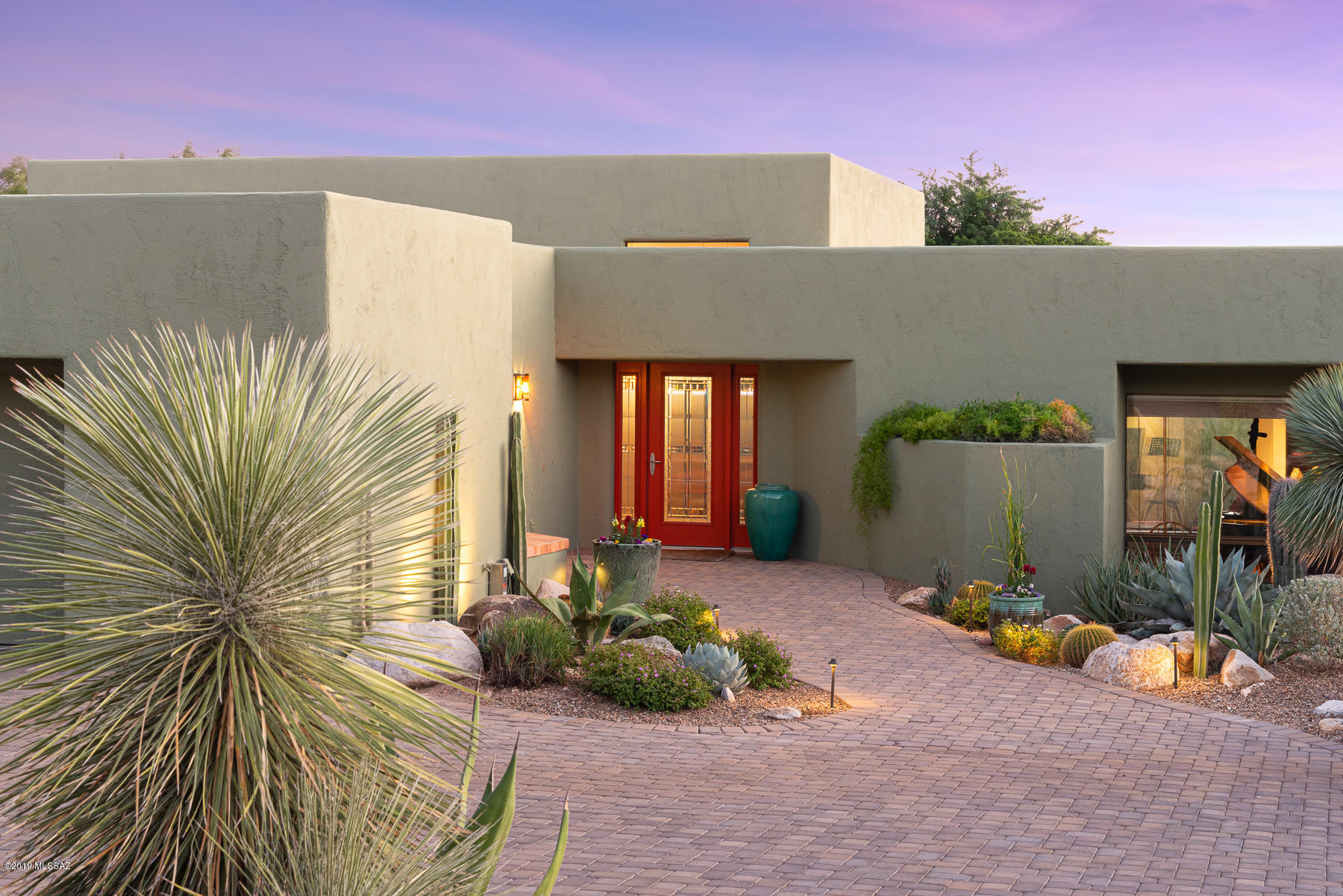 Located in gated Sin Vacas w/privacy & dramatic mountain views, this 3,370sf 3BR/2½BA elegant custom southwest-style home compliments the natural beauty of this unique foothills setting. Blended with a modern flair while keeping the classic warmth of Southwest Style, kitchen has stainless appliances, Fisher & Paykel Range & mesquite counters. Family room off kitchen has library wall & fireplace. Formal dining area & formal living room. Like a tranquil walk in Tohono Chul Park, this property features walkways w/over 100 exquisite specimens of Native Tucson Area Cactus & Succulents. Home features Saltillo tile, Tongue & Groove Ceiling w/wood beams, New Exterior paint 2019, Newer HVAC & HW Heater & paver stone driveway. Relax in the privacy of your backyard w/Lap Pool. 2-car garage.