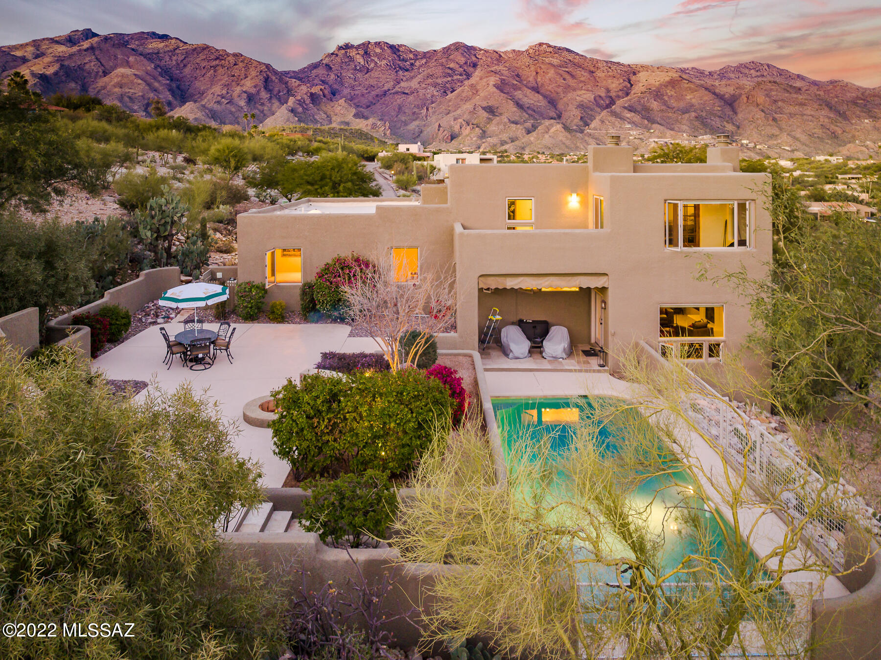 Immaculate, tastefully updated southwestern style home w/ a modern flair conveniently located in the heart of the Catalina Foothills in Cimarron Foothills Estates.   Enjoy true privacy on this  1.14 acre ridgetop lot w/ sensational mountain, city & sunset views. Distinctive front courtyard covered w/ flagstone leads to custom solid wood front door & bright entry.  Upon entry, a perfectly placed large picture window frames the sweeping views of the valley below & the natural desert.  Spacious living room w/  magnificent natural light has high, wood-beamed ceilings & an impressive fireplace. Adjacent formal dining room leads to the upgraded gourmet kitchen featuring granite counters, upgraded soft-close cabinets w/ custom built-in wine rack & glass holder, stainless steel appliances, CONT.. hammered copper dual farmhouse sink & breakfast bar.   Kitchen opens to family room w/ bar area w/ sink & stainless steel wine cooler. Split bedroom floor plan features 4 bedrooms & 3 bathrooms-each bathroom is upgraded w/ travertine slab counters, travertine tile surrounds, soft-close cabinets & newer fixtures.  Views from every window in the private master suite w/ fireplace &  135 square foot Arizona style sitting room & walk-in closet. Master bathroom w/ dual sinks, newer fixtures, separate shower w/ travertine surround tile & accent details.  Additional interior features include polished travertine floors throughout w/ carpet in bedrooms, all new Milgard windows installed in 2018 w/ 10 year warranty, new Hunter Douglas blinds throughout the home, new Bosch refrigerator & dishwasher, new Electrolux built-in microwave & upgraded laundry room w/ extra storage cabinets & granite counters.  Dreamy backyard oasis w/ covered patio, pool & firepit is completely finished w/ low-care landscape/hardscape leaving the new owner w/ nothing to do but enjoy the exceptional privacy & views.  2020 full renovation of the pool area w/ new pebble tec surface, poured concrete deck & pentair pump & filter. 2-car garage w/ brand new epoxy finish & large motorcourt for additional parking.  Major system upgrades include re-coated roof (2021), two 17-seer Trane units w/ variable speed air handler (2019), new water heater (2018), whole house water treatment system w/ RVO tap in kitchen (2020) & new exterior paint (2018). District #16 Schools including Ventana Vista Elementary w/ Highly-Acclaimed Spanish Immersion Program. Incredible Foothills Location within Minutes of the Best Shopping & Restaurants Tucson has to Offer. Close to World-Class Golf Resorts & Country Clubs and Tons of Hiking & Biking Trails including Sabino Canyon.