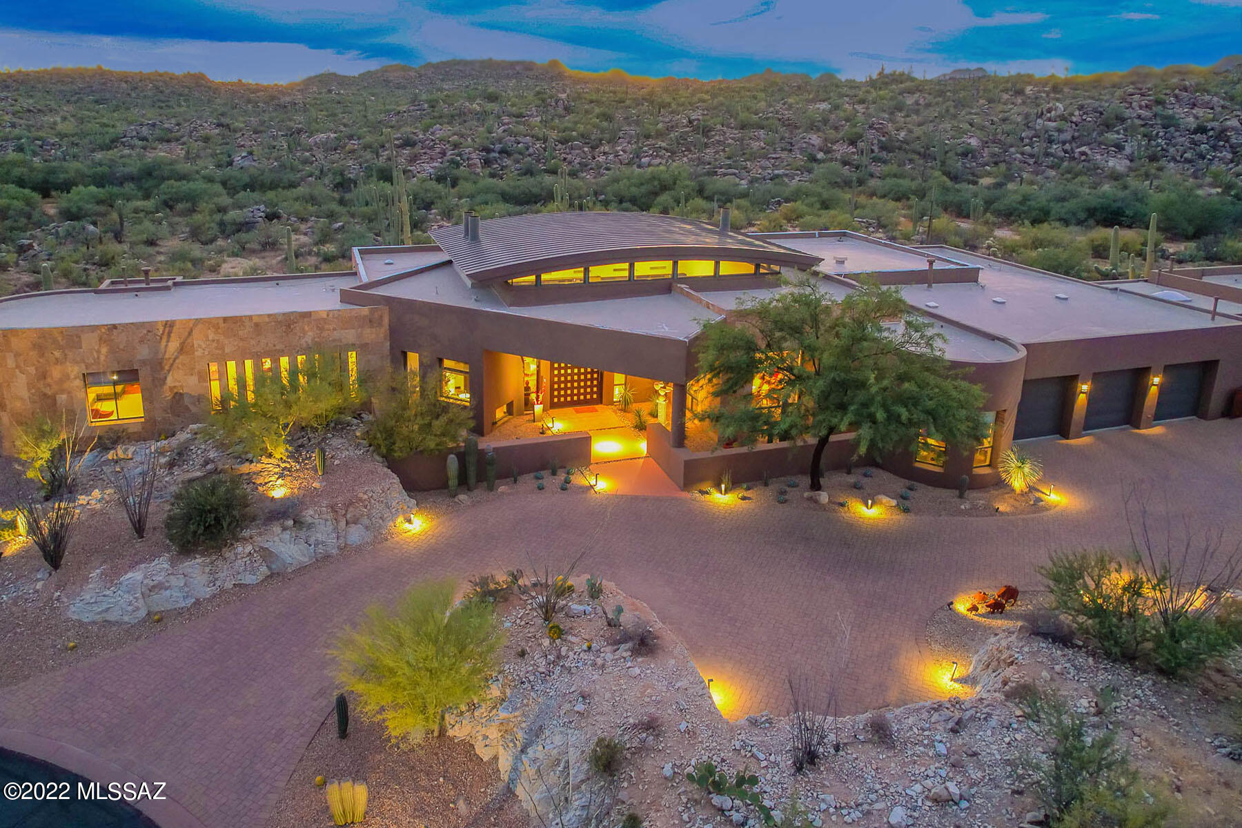 Stunning Contemporary masonry home designed by Ron Robinette in the exclusive guard-gated Honeybee Ridge Estates. Timeless architecture, thoughtfully designed to capture views in all directions. 
As you walk through the pivoting front door, you will feel the constitution, revealing unobstructed floor-to-ceiling views of the Catalina Mountains, Pusch Ridge, Tortolita Mountains, and Tucson City Lights. This spectacular wall of windows opens up completely to the covered patio and lap pool and striking landscape of the protected Honey Bee Canyon! Clerestory windows providing not only a dramatic architectural feature at the same time adding natural light.
Easy flowing open floor plan light and bright with each room capturing the privacy and views! Four Bedrooms, all ensuite, in the main CONT house. Vaulted tongue and groove wood ceilings, scored polished concrete floors, and deep-covered patios. Built with all quality finishes with Masonry construction.
The kitchen opens to the family room with new appliances, plumbing fixtures, and a new bar counter. 
The spa-like master suite features a soaking tub surrounded by windows that capture the beauty of our Sonoran Desert. Dual vanity, large walk-in closet, and spacious separate shower.
Entertaining inside or out with a large lap pool and spa, outdoor covered kitchen, and large fireplaces. With uncompromised design, incomparable views, a serene setting, and privacy, this home has it all!