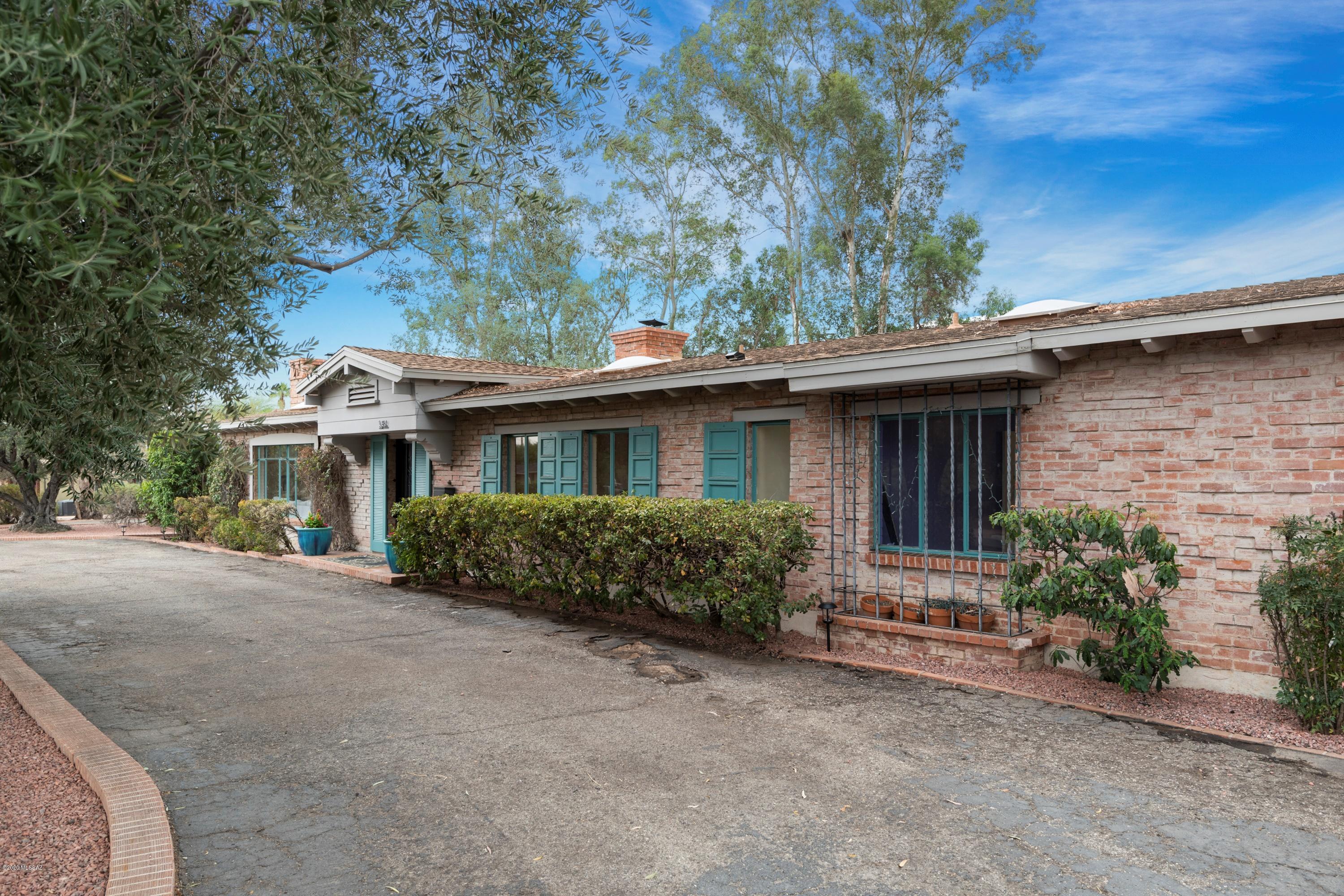 Beautifully updated 1950 original Joesler designed home situated on 3/4 acre lot. This sprawling Ranch mirrors Tucson 50's architecture. With amazing curb appeal, this home has been featured in several newspaper and magazine articles. The exterior is one of Joeslers few double brick homes built in Tucson with a mortar wash exterior. The charm starts with the front entry and continues throughout the home with beamed ceilings in the living and Sun Room, Guest Bedrooms, Master Bedroom, Office and Dining Room. Updated kitchen is a chef's dream with restaurant quality appliances and custom soapstone counters. Three fireplaces throughout. The unique backyard is perfect for gatherings with several large old trees, large pool, original brick BBQ and several areas for entertaining at its best!