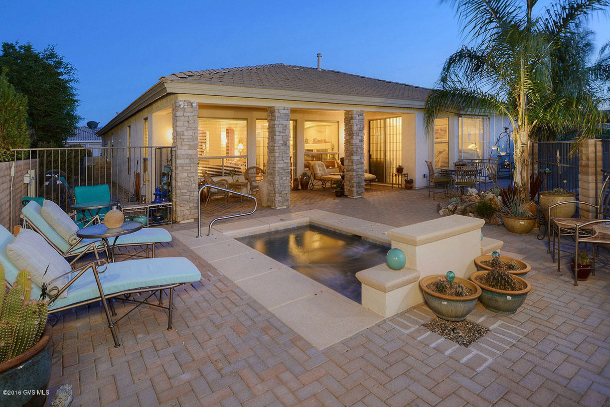 Beauty starts from the lovely front courtyard thru to the views of the golf course! This upgraded ''Cimarron'' model has a casita with bath plus 3-car garage. Enjoy the spool with jets that are remote controlled. Other features include gas fireplace, tile floors, granite counter tops, sliding french doors, bay window, surround sound, wood blinds, water treatment system, and the list goes on... You just have to see this one!