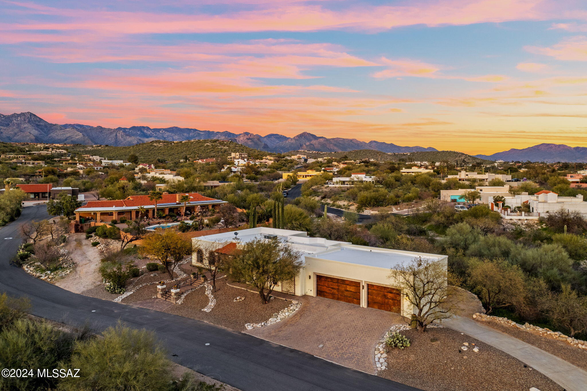 Welcome to this custom foothills home, with a stunning blend of beauty and function. The elegant stone finishes start outside with the paver walkways, front patio and stone columns. They continue into the home past the custom metal french entry doors. Travertine floors are perfectly accentuated by the plantation shutters, alder doors, and unique finishes throughout. The indoor spaces seamlessly flow into the backyard patios and outdoor kitchen. With a fourth bedroom off a separate living room and office space, the layout could serve as a private guest casita. The 1200 sq.ft garage ensure plenty of space for your cars and toys. This home offers a combination of timeless design with modern features you will not want to miss it.