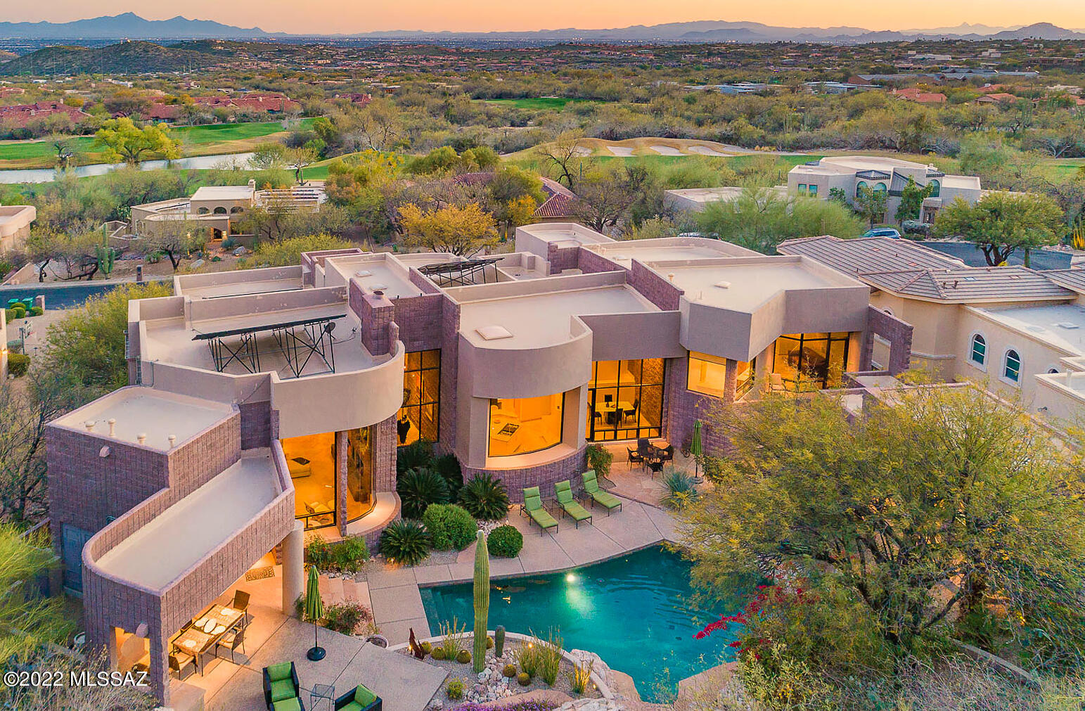 Ventana Canyon's finest resort-style 5bed/6bath contemporary home, designed with every detail & finish crafted with the highest standards, creates living spaces that exude luxury, while remaining warm and inviting. Exquisite front entrance welcomes you into this timeless 7866-sf architectural masterpiece, boasting high ceilings, Travertine tile flooring, Family Room with wet bar, top-of-the-line solar upgrades that produce 170% of energy usage, & home automation upgrades throughout. Natural light pours into main level thru a multitude of windows, highlighting spacious living areas & sweeping city and mountain views at each turn. Entertain guests in kitchen with walk-in pantry, breakfast bar, and high-end appliances- that flows effortlessly to surrounding dining areas. Sumptuous Primary Suite includes sitting area, remote-controlled fireplace, custom walk-in closet, spa bath with Zen-like soaking tub, private sun deck with access to backyard. Relax in the private backyard oasis, offering covered flagstone patios, firepit, pool, spa, pool bath, waterfalls, & overhead remote-controlled heater in outdoor kitchen with built in BBQ. Other quality features include solar roof panels, Sonos surround sound, & circular driveway leading to spacious 4-car garage with Tesla electric vehicle charging station.