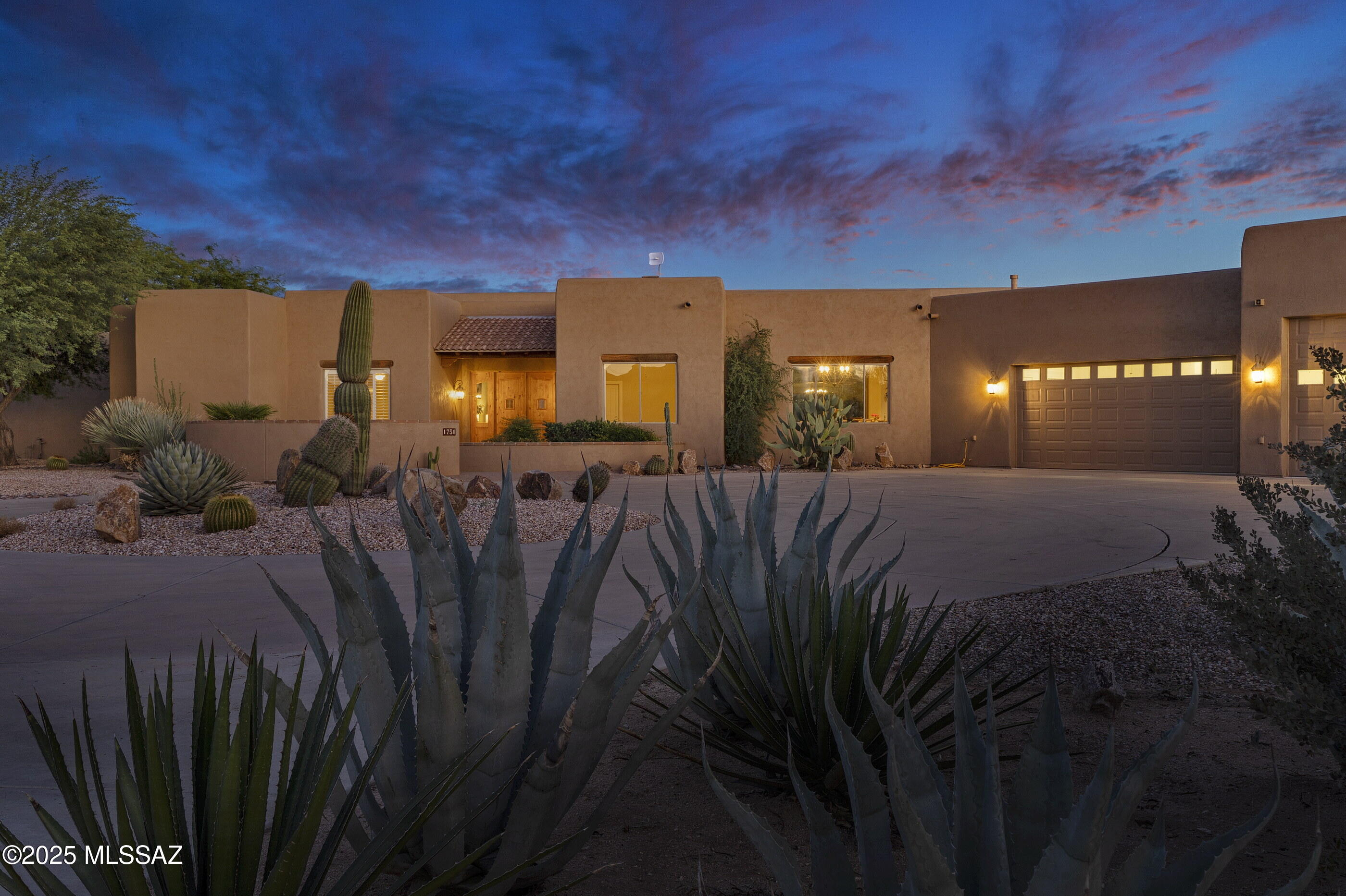 Discover a rare retreat in the heart of Oro Valley, set on 4.55 pristine acres with no HOA restrictions and the benefit of a private well. A long, circular concrete driveway leads to a dramatic entry that opens to retractable sliding glass doors, seamlessly framing breathtaking views of the Santa Catalina Mountains and extending your living space outdoors. Inside, the great room captivates with soaring wood-beamed ceilings, a stacked-stone gas fireplace, and timeless natural stone floors—anchoring the home with warmth and character. This custom five-bedroom, four-bathroom residence offers unmatched privacy, classic design, and sensational views in every direction—unobstructed Catalina Mountains, the Tortolitas to the north, sparkling city lights, and endless desert sunrises and sunsets The chef's kitchen is a true gathering place, featuring granite countertops, a large center island, breakfast bar, custom cabinetry with plenty of storage, walk-in pantry, and premium stainless-steel appliances. A sunny breakfast nook and a formal dining room provide ideal settings for both relaxed mornings and elegant evenings.
The primary suite is a private haven, with patio access, a spa-inspired bathroom offering a walk-in shower, soaking tub, dual-sink vanity, and a generous walk-in closet with custom built-ins.
Outdoor living is at its finest here. A wraparound covered patio opens to a resort-style backyard with a fenced pool, beautifully landscaped low-care grounds, and sweeping mountain and city views.
Car enthusiasts will appreciate the oversized 1,700 SF six-car/RV pull-through garage, designed with epoxied floors, dual front-and-back entry doors, a workshop with stainless-steel sink, and separate storage with custom built-ins.
Though private and secluded, this desert sanctuary is only minutes from all that makes Oro Valley exceptionalrecently recognized as the safest affluent retirement community in the U.S. Catalina State Park, The Loop's 131-mile bike path, premier shopping and dining, and world-class golf clubs including Stone Canyon and The Gallery are all close at hand. With quick access to I-10 and Phoenix Sky Harbor Airport, this property offers the perfect balance of tranquility and convenience.