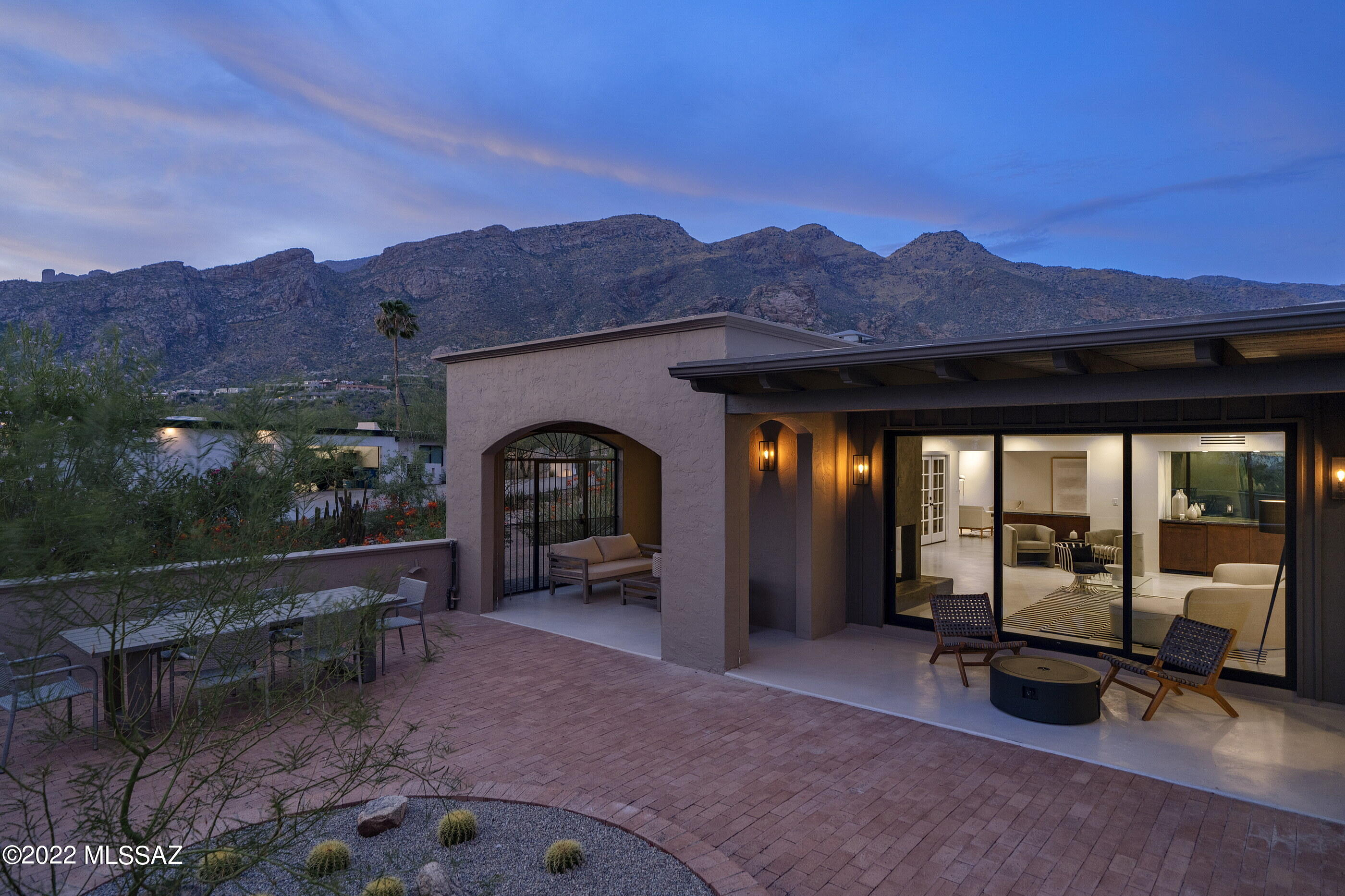 This re-envisioned 2,391 square foot home, located in the highly sought after Skyline Country Club community and anchored by 24 hour guard gated security, is designed to be utilized as a secondary home, or full time residence. The entry is carefully choreographed through a beautiful courtyard, flanked by native plants and trees, creating an inviting user experience. Opening onto an interior layout allows for design, space, and function to merge, informing one of the overall architecture and interior decor vision. From the entrance hall, the house opens through to a set of panoramic windows, arranged around a central courtyard-terrace overlooking the greens of the adjacent Country Club, while amplifying the connection between the indoor and outdoor spaces. Southern exposure, with large covered overhangs provide protection from the natural elements, taking full advantage of the ideal passive solar orientation. 

The interior palette and mood is complemented through the use of smooth gray concrete floors, juxtaposed against timbered ceilings and warm wood tones that preserve the serene atmosphere of the house and its surroundings. The primary functions of the house face South, with the kitchen, dining, and living rooms occupying the center of the plan, while the owner's suite is privately sequestered on the SouthEast end of the residence and a secondary guest ensuite discreetly located at the opposite end of the corridor. 

Materials are selected to extend the intention of the original detailing, with quartzite stone tile set against chrome-plated hardware, and walnut-toned woods dressed in dark granite with silver veining, all coming together to enrich the timelessness of the design. Some of the recent updates include: HVAC, roof and skylights, Arcadia doors and windows, all new Electrolux appliances, plumbing and lighting fixtures, cabinetry and countertops, concrete floor overlay, cobblestone driveway, updated landscaping, and new exterior gates. 

About Skyline Country Club:

Developed in 1959 by John Bender and Leonard Savage, who dreamed of a luxury Golf Course community, making it permanently accessible to privileged residents, members and guests. Skyline Country Club and Resort, as they originally called it, would become one of the first large-scale developments in the prestigious Catalina Foothills. 

The rugged backdrop of the Santa Catalinas and hawk-eye views of the Tucson valley, provides the perfect setting for this 18 hole, par 71 golf course that winds its way through the Sonoran Desert Foothills, providing a unique golf experience amidst nature's beauty.