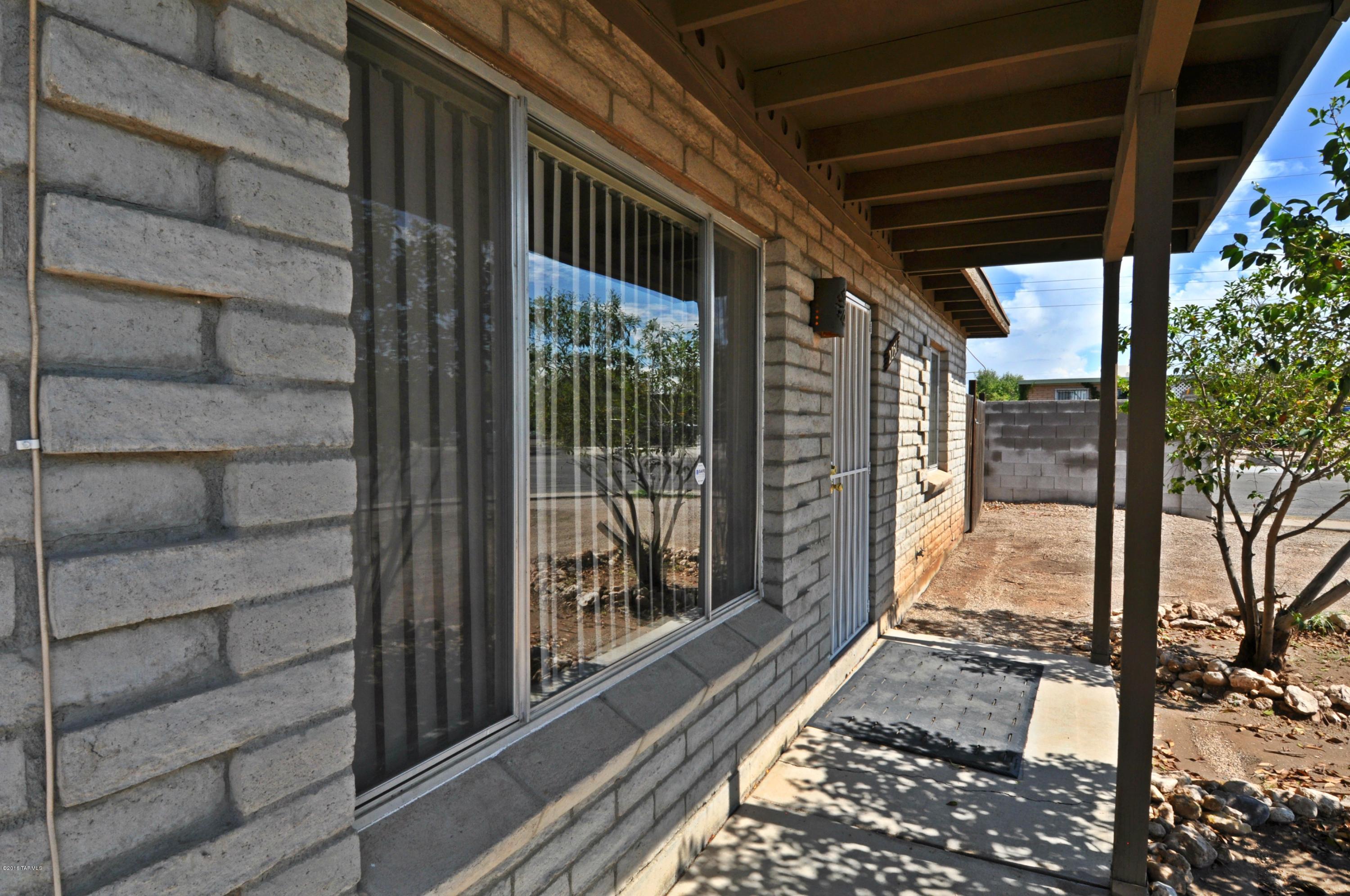 Corner, cul-de-sac! ONE YEAR OLD AC/FURNACE!! Built w/extra insulation! Aug 2016 Elec bill only $88.18 w/AC on at 78 degrees! 2 BIG original BRs, both w/oversized closets. Cutest ever, Updated Bath! 3rd BR has walk-in closet across its hall. Recent Carpet & Saltillo tile! Honey Oak Kitchen w/deep double-basin sink, nice range & refrigerator. Dining area w/fan & slider to patio. The Addition adds much flexibility & includes: BR3 w/window &wall AC, Den w/ext door to front, carpeted walk-in closet, large laundry/storage (perhaps adapt for 2nd bath) & wide hallway w/door to kitchen & door to rear yard. Cov patio w/WALLED YARD W/EAST EXPOSURE. You can see the Mtns from the back yard! Plumbing set up for water softener at rear of home. Concrete off-street parking that’s easy to gate, if desire