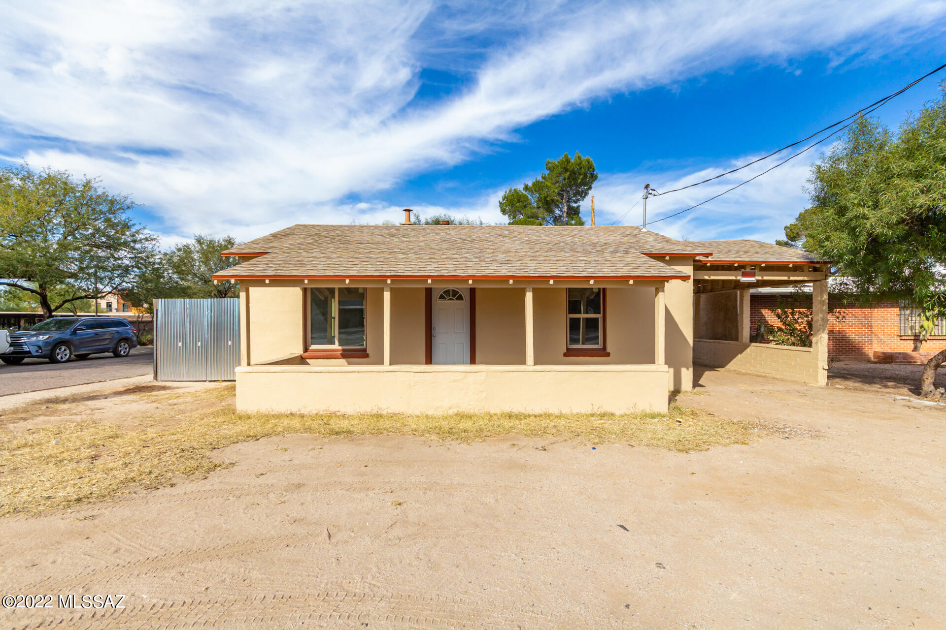 Own this single-story home in a coveted corner lot. Great location surrounded by aesthetically attractive commercial office buildings ! Use as a home or convert the zoning to commercial use .  Come finish the details of this space using your own personal touches.  Build sweat equity!   Included is: new 200 AMP service, Exterior all repainted, new energy efficient windows, and new roof. Home is all electric.  Comfortable floor plan. Great location - a few minutes away from downtown Tucson, near business establishments and schools.