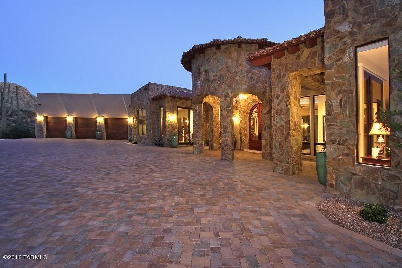 Spectacular property! Uncompromising VIEWS, LUXURY and PRIVACY. Set high in the exclusive guard gated Canyon Pass @ Dove Mountain community w stunning mountain & canyon views throughout. Dual master suites. Private master suite features rock fireplace, lavish bath and expansive closet w built in luxury. 2nd master outfitted w state of the art theater system. Guest bdrm & 4bdrm/Office w ensuite baths.  Chef's kitchen is a dream w SubZero refrigerator and Wolf appliances. Wine Room. Travertine tile. Amazing attention to detail! Car/Toy enthusiasts will love 3car attached garage and 8car+storage detached garage(easily converts to guest house!) 11 CARS! Incredible outdoor living spaces. Full outdoor kitchen, 2250 sqft cvrd porches, Salt Water Pool/Spa and BREATHTAKING TOP-OF-THE-WORLD views!!