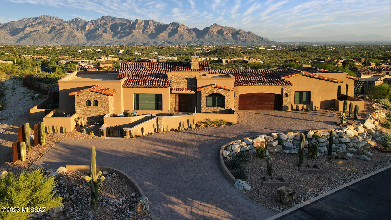An exceptional Marc Soloway designed residence in Tucson's Stone Canyon Club, the premier, private, guard-gated golf community in So. Arizona. Featuring elevated, non-obstructed, fully protected, 360-degree views of the Catalina mountains, Tucson city lights, and Tortolita mountains. 3907 sq ft interior living space finished with the finest choices. Featured in Luxe lnteriors and Design Arizona Spring '23 magazine for First-Place ASID award-winning residential outdoor living space design (Deluxe Designs of Arizona.) Built in 2020 and in immaculate like-new condition. 12-foot ceilings, over-sized Italian porcelain flooring throughout with luxurious Fabrica carpet in the bedrooms. See the attached Features & Description PDF for the extensive list of amenities or contact agent for more info. Features and Detailed Description - 14572 N. Shaded Stone Place

This is one of the exceptional pieces of property in Tucson's Stone Canyon Club, with elevated, non-obstructed, fully protected, 360-degree views to the Santa Catalina mountains, downtown Tucson, the Tortolita mountains, and more. The home perches on top of a hill in a quiet neighborhood within the larger community.

Stone Canyon Club is the premier, private, 24-hour guard-gated golf community in southern Arizona and sits in the foothills of the Tortolita Mountains in Oro Valley, Arizona. It offers the Jay Moorish Signature Design championship golf course, a luxurious health and fitness facility, a gourmet restaurant and bar, as well as leagues, clubs, and amenities for all ages.

Designed by prominent Arizona architect Marc Soloway, this beautiful home offers:

Just over 3,900 square feet of interior living and more than 2,000 square feet of exterior living, everything finished with the finest choices.

The primary living spaces have the highly desired eastern exposure, with breathtaking views of the Santa Catalina Mountain range, downtown Tucson and many of Tucson's surrounding mountain ranges.

The property is adjacent to 33 acres of conservancy land, protecting the entire northern exposure from future development.

The home is three years new, with very light occupancy.

The home was featured in Luxe lnteriors and Design Arizona Spring '23 magazine for First-Place ASID award-winning residential outdoor living space design (Deluxe Designs of Arizona)

lnterior highlights:

Living areas feature 12-foot ceiling heights with Western Windows sliding doors and windows to take in gorgeous views. All doors and windows are custom-tinted and have powered Hunter-Douglas custom coverings. ln addition, nearly every window has a Tucson Rolling Shutter mechanized solar screen on the exterior for additional sun protection.

The home offers a beautifully designed, well-appointed gourmet kitchen with inset-style maple cabinetry finished with cast brass hardware from Top Knobs artisan collection. A cook's kitchen, the home has some of Wolf's latest appliances, a Sub-Zero refrigerator / freezer, a Bosch dishwasher, and a custom-designed pantry with over 300 linear feet of storage. The center of the kitchen is a gorgeous K-2 granite waterfall island with plenty of seating. The striking backsplash is designed and hand made at Tabarka of Scottsdale.

Adjacent to the kitchen is a dining room with a stunning Los Angelas artisan Cisco Pinedo salon-glass canopy pendant light, a wall of windows overlooking the Tortolita mountains, and a 10-foot-long wet bar with a Sub-Zero wine refrigerator, U-Line beverage center, Fisher-Paykel dishwasher, and a prep sink with garbage disposal.  Above the K-2 granite countertop is another custom-designed, hand-painted backsplash by Tabarka.

The great room features a fabulous Montigo Distinction fireplace with multi-color LED uplighting, ceramic glass and a driftwood log insert. The fireplace and cool wall are accented on both sides by glass display shelves and hand-hewn wood parquet accent walls by Tabarka.

Flooring throughout the home is an over-sized, easy-to-maintain, neutral Italian porcelain tile, with neutral, luxurious Fabrica carpet in the bedrooms.

There are solid Alder doors throughout the interior, as well as the front door and side-lights which were custom made by Krausch.

The beautiful master suite offers wall-to-wall sliding glass doors that allow you to take in the sunrise over the Catalinas every morning. The master bath features a beautiful peninsula with custom cabinetry and a natural white quartz countertop. The focal point is a large custom mirror designed by Lori Carroll and built by Extreme Metalworks, set off by Juliska crystal light fixtures. The bathroom also has a built-in linen cabinet, a large two-person shower, and a Victoria and Albert soaking tub from which to enjoy the beautiful view out the bathroom's wall-to-wall windows.

The master closet is spacious, designed with all the storage features one could want, as well as a second full-size washer and dryer set.

The family room is generously sized, offering plenty of room for entertainment as well as an exercise space. There is a large storage closet off this room.

The highlight of the beautiful powder bath is a custom-designed vanity built with the extremely rare mystic pearl granite, set off with two more Cisco Pinedo pendant lights, a turquoise glass vessel sink, and gorgeous Kallista rose gold fixtures.

The home offers a 40-foot-long gallery hallway to display artwork, which leads to a separate guest wing.

The guest wing features two separate ensuite bedroom / bathrooms with custom-designed walk-in closets. The bathrooms throughout the home all have porcelain Toto toilets and sinks, Tabarka backsplashes, Brizo fixtures and designer lighting.  A Tara Shaw original plaster-cast mirror hangs in one of the guest baths. Adjacent to the guest bedrooms, there is a private guest / hostess bar with another Sub-Zero refrigerator. Guests also have their own exterior door that leads to a private patio facing the Catalinas.

The generously sized, beautifully finished laundry room offers more custom cabinetry with endless storage, K-2 granite counters, and another artisan backsplash from Tabarka. 

The counter electrical around the kitchen, along the wet bar, and in the laundry is the under-cabinet LeGrand system, providing power, lighting and other useful features while not interrupting the custom artisan backsplashes.

A Control 4 smart system controls the lighting, climate, window shades, water leak detection and whole-house shutoff, exterior camera, and security system. The home is fully wired for home entertainment.

Other features include a whole-house osmosis water system and water re-circulator; dual-zone HVAC with an additional cooling unit in the garage; and soundproofing sheetrock around all bedrooms.

Exterior highlights:

This home offers over 2,500 square feet of fully-enclosed travertine patio spaces, giving you and your guests numerous choices to relax and enjoy the breathtaking desert southwest views.

A private front courtyard gives you a front row seat to the beautiful foothills of the Tortolita mountains and breathtaking sunsets. And after a good monsoon, you can watch your own waterfall on the mountainside in front of you.

The back of the home has multiple seating areas. The covered patio space offers an expansive seating and dining option, and also has an additional sunscreen allowing a partially screened-in patio when desired.

Enjoy elevated lounging areas on either side of the beautiful, turquoise-glass tiled 15-jet spa / pool with copper scuppers. Or sit and warm yourself in front of the long, curved fire pit filled with decorative ceramic fireballs. Guests can also enjoy their own private patio. The mountains, the downtown lights and a nighttime sky of stars in this dark sky neighborhood are all visible from anywhere around this home.

Play a round or two on your own custom-built putting green or fix a delicious dinner at your outdoor grill and pizza oven kitchen covered with Westerner Alumawood pergola.

There is an easy-to-set-up / take-down 500 square foot shade sail for additional sun protection on the patio during warmer months.

The property boasts beautiful drought-tolerant landscaping with feature plantings set off with custom-made metal accents, spotlighting the most magnificent specimens of the Sonoran Desert.

Other exterior features include an extra-large (3,100 square foot) Belgard paver driveway with two separate parking areas; custom iron metalwork, fencing and gates that surround the home; 250 running feet of javelina and snake protection fencing; a fully enclosed side garden with pet-friendly turf; and a four-zone irrigation system.

Most exterior and interior furnishings are available for sale if there is interest.