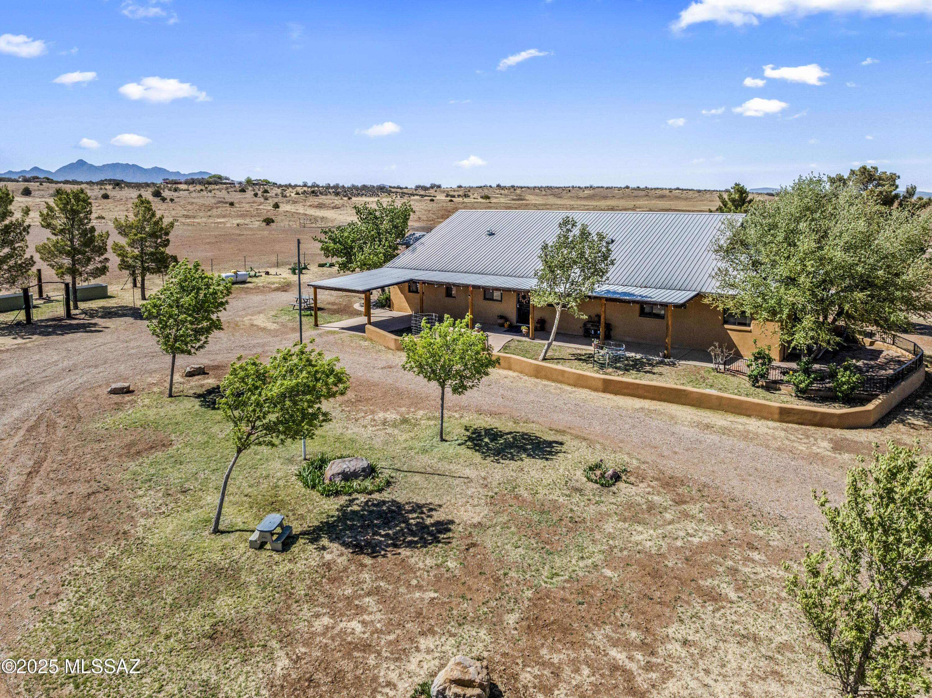 Amazing Ranchette with end of road Privacy! Enter through Custom wrought iron gates to a large circular drive w/mature trees & visible sweeping MTN Views in All directions! Hay barn, workshop, tack room, Roping arena, pipe corral, 3 Large fenced pastures, 2 water sources-Private solar well & 5 way well share, Vego garden beds & 2nd septic system installed for future GST home etc.  Elegant home w/Metal roof, Cov'd porch, semi enclosed rear patio, attached 2 car garage & single carport. Lovely Great room w/Gas FP, overhead beams & wood built-in. Gorgeous kitchen w/Granite counters, large prep island, SS appliances, custom wood cabinetry, buffet table. Spacious primary Bdrm w/walk-in closet, 2nd Gst Bdrm off primary can serve as a Den/craft & 3rd Bdrm Gst suite w/newly remodeled Gst bathroom This is a fantastic property offering many amenities & no HOA in a stunning setting with nearby Forest access. Exterior of home just painted 4/25. If you are looking for a ranch get-away in a scenic location that is well cared for, do not hesitate to see this beauty!