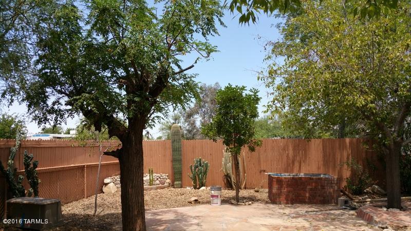 Beautiful outside garden and patio with pond and water fall with this up-dated home. Totally fenced for privacy. This 2 bedroom 2 bath has an island kitchen, rock fireplace in the living room  French door on to outside patio. Has large inside storage room off the laundry room along with a large shed for additional storage.  The master bedroom bath has dual sinks, garden tub with a separate shower. Close to shopping and a quick jump onto the freeway.