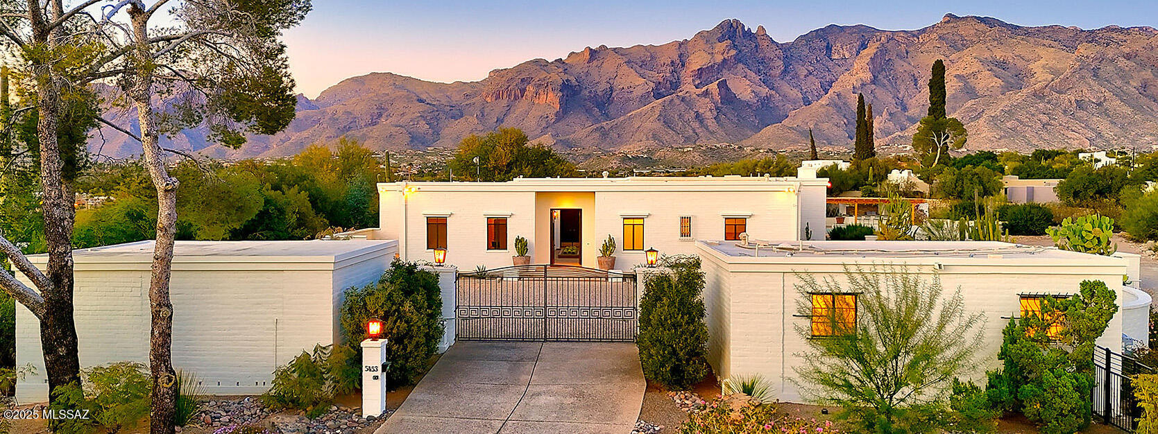 Historic Tucson Estate: 5453 N. Camino Real, Tucson, AZ
 
Located in the Old Catalina Foothills, the distinctive property at 5453 N. Camino Real is a true gem, reflecting a rich architectural heritage and history. As you arrive, the driveway brings you to a gated and walled parking court forming a private and secure compound filled with lush desert plantings. Set on nearly two acres, the main house is constructed from traditional mud adobe brick and spans 4,508 square feet, featuring three spacious bedrooms, each with its own ensuite bathroom, and an additional half-bath in the guest wing. There are an additional 2 bedrooms and full bath in the separate guest house spanning 591 square feet. A beautifully landscaped courtyard leads you to the entryway of the home.  Natural light fills the home, enhanced by the original steel casement windows and enormous sliding glass doors showcasing spectacular views of the Catalina Mountains. Inside, the entertaining areas are adorned with intricate hand-carved moldings throughout and a marble fireplace, adding a touch of elegance and fine craftsmanship to the spacious living and dining rooms. Just off the main foyer there is an office filled with built in bookshelves currently being used as the media room. The eat-in kitchen retains its original vintage steel St. Charles kitchen cabinetry, equipped with a large pantry and separate laundry room.  The flow of the house is one of its best features - with one wing dedicated to bedrooms and the other to entertaining all wrapped around the central courtyard.

The property boasts a huge, flat backyard that has been recently and beautifully redesigned, perfect for hosting large gatherings and offering a spectacular setting for outdoor entertainment. There is gorgeous pool and a newly built wooden pergola that houses a dining area and full outdoor kitchen, ideal for year-round enjoyment and entertainment. These features make the property not only a place for relaxation but also a perfect venue for memorable gatherings.

This home was originally built in 1959 for John Chiappetta, the founder of the former Bank of Tucson, marking its importance in the local architectural and social history. Frances Davison Cheney, known for her impeccable style and entertaining, once owned this home and chose George Stacey, a celebrated interior designer, to enhance its interiors. His influence adds an additional layer of sophistication and historical value to the property.

Recent updates include new whole-home Generac back-up generators and a state-of-the-art HVAC system, ensuring modern comforts such as a comprehensive water softener system.

Improvements:

Kitchen - demo'd bathroom in kitchen
Demo'd 2nd kitchen along the hallway
Moved the island over and centered it to room
Partitioned off pantry and laundry room
New washer dryers
New refrigerator
New beverage refrigerator
Repainted kitchen
Removed black tile backsplash throughout kitchen
New butcher block countertops on island, in laundry room and pantry
Regrouted floor tiles in kitchen

Dining room - just repainted

Living room - removed moldings,
removed window treatments and wooden covers over windows,
repainted
closed up the entrance to the office/media room

Office - re-opened original door to center entryway of house
Repainted

Bedroom hallway

Regrouted tiles in hallway

Master bedroom
Repainted
Filled in pony wall to make separate office/sitting room area
New lighting over mirrors

Entire house interior and exterior repainted

Brand new giant HVAC systems for main house and guest house

New HVAC ductwork

2 giant back up generators for main house and guest house

Tankless hot water heaters main house and guest house

New lighting throughout house

New window treatments throughout house

New roof on guest house

Landscaping
Completely new interior courtyard
New pergola over outdoor kitchen and dining area
Completely redesigned backyards and side yards
Completely new motor court landscaping
New pool equipment
New irrigation system (separated from main house water)
Removed all nonfunctioning fountains from property (three)
Removed patio overhang roof
Fenced entire property with snake proofing

Other things to main house
Main house water softener system - whole house
New insinkerators
New alarm system
New toilets in all bathrooms