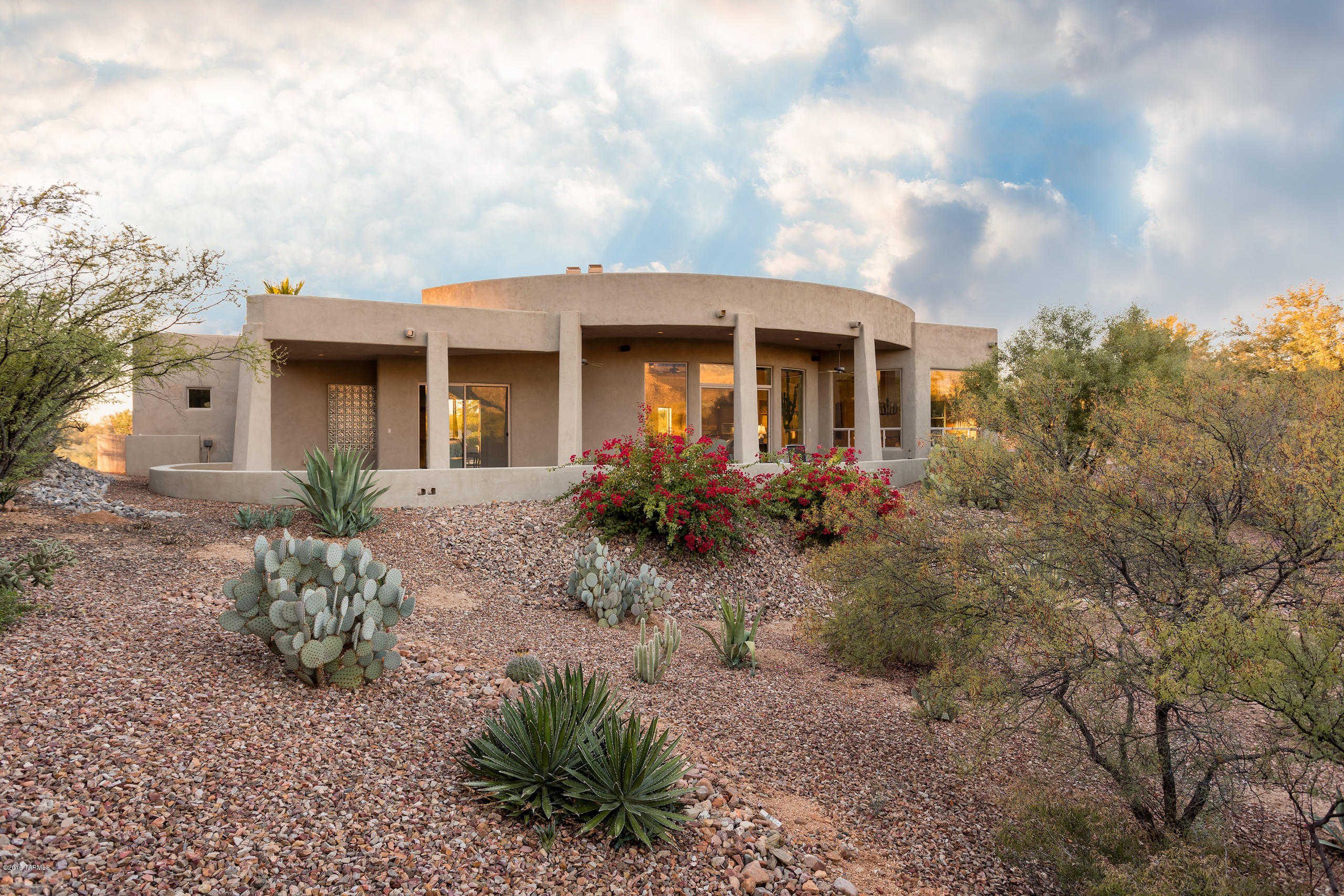 Stunning contemporary on premier lot in gated Palisades Point Estates.  Spacious and open with amazing 360 degree views. Over 1400 sq ft of covered outdoor living space includes the rear patio with pebble tec pool, outdoor kitchen and fireplace as well as the expansive front patio offering some of the best mountain views in Oro Valley. The split bedroom plan is ideal for guests and offers a bonus room ideal for den or additional office.  Amenities include 18'' Travertine tile and slate flooring, alder wood cabinets, extensive recessed lighting, commercial grade misting system on rear patio, 3 fireplaces, a built-in office in fourth bedroom, niches throughout  as well as a wall of built-ins in the 3 car garage.