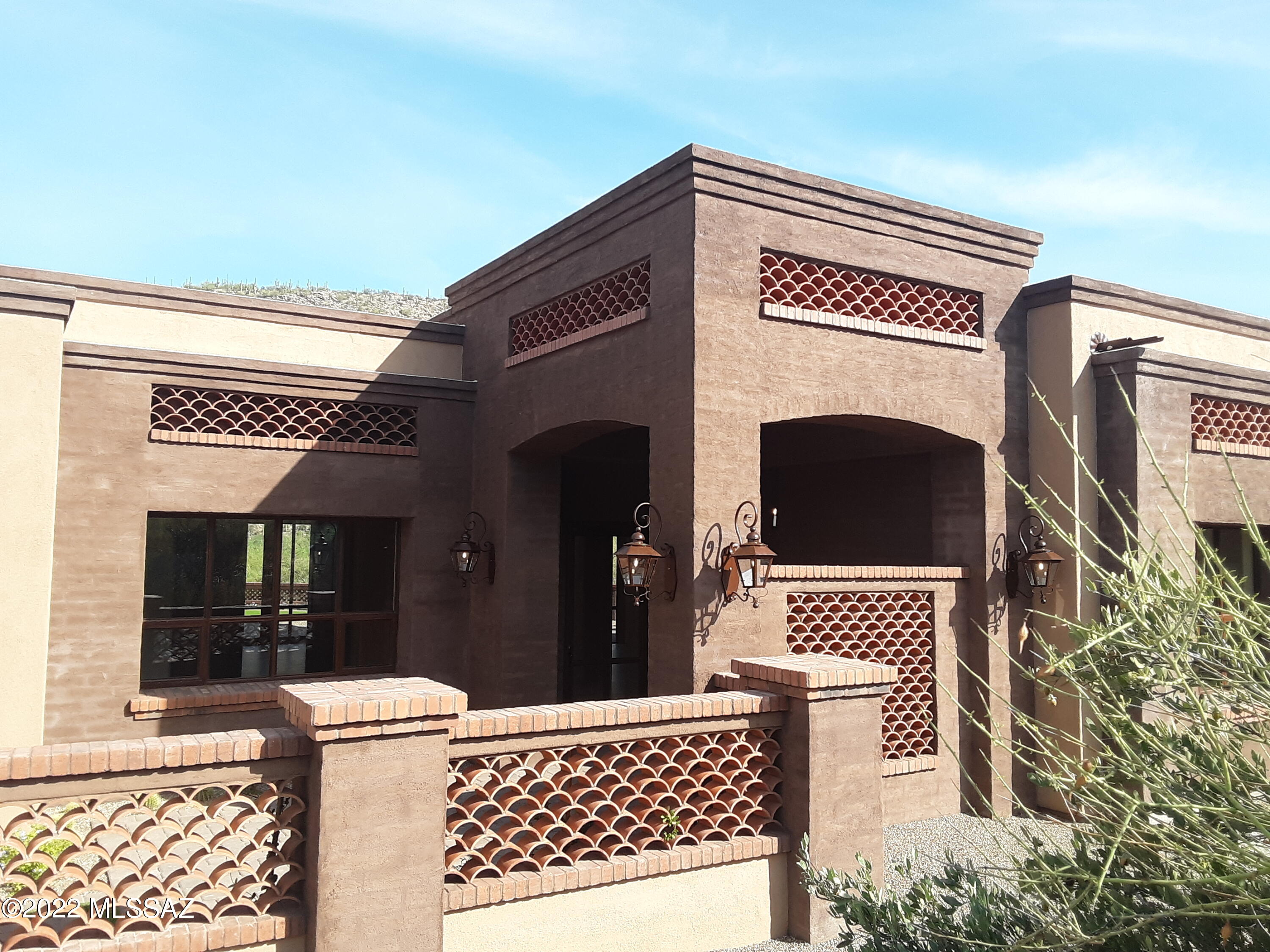Spectacular views from this new Quintana Partners LLC construction nestled on the Gallery golf course between the 3rd hole & 4th tee box. This contemporary southwest design features a Great Room w/ 14' ceilings, Integral color plaster Foyer, Solid 8' Alder doors. Custom Alder cabinetry, Thermador Appliances, 10' kitchen island w/ waterfall edges and a Wine closet. Prewired for speakers in Great room, Master Suite and Patios, 3 Bedrooms and Office /Den, 3 and 1/2 baths. Low maintenance landscaping on a drip system.
Artificial turf and desert landscaping. Available for additional cost, there is a backyard plan from Pools by Design.