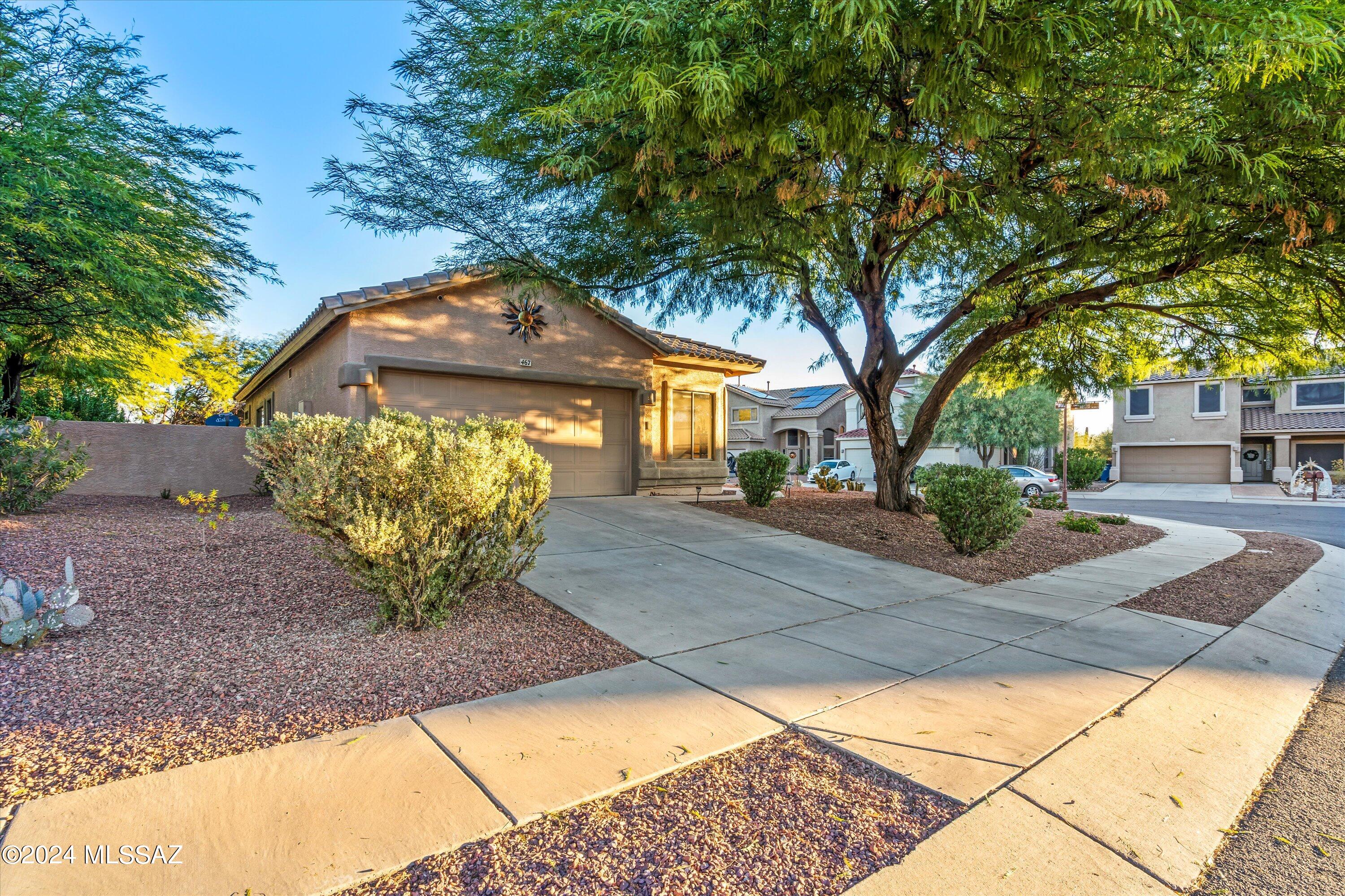 Meticulously updated home located on a generous sized corner lot in Rancho Sahuarita, ready for you to move right in.  New Sophisticated ceramic and porcelain tiled floors throughout, quartz kitchen countertops, black-stainless steel kitchen sink, Kohler touchless faucet, modern light fixtures and ceiling fans, primary bathroom quartz countertop with a rustic wood/iron mirror and a luxurious walk-in tiled shower equipped with a Kohler cast-iron shower base and a lavish rain shower head, new cabinet hardware and new interior premium paint.  Beautifully landscaped backyard with pavers, fruit trees, Rain Bird automatic irrigation system, snake fence, covered patio and pergola for year-round enjoyment.  Plus, a water softener system for the entire house, recently installed gas water heater and HVAC, Stainless steel appliances and water purification system by reverse osmosis for best drinking water. 
Perfect blend of style and functionality. Perfect first or retirement home.  Welcome to your beautiful oasis!