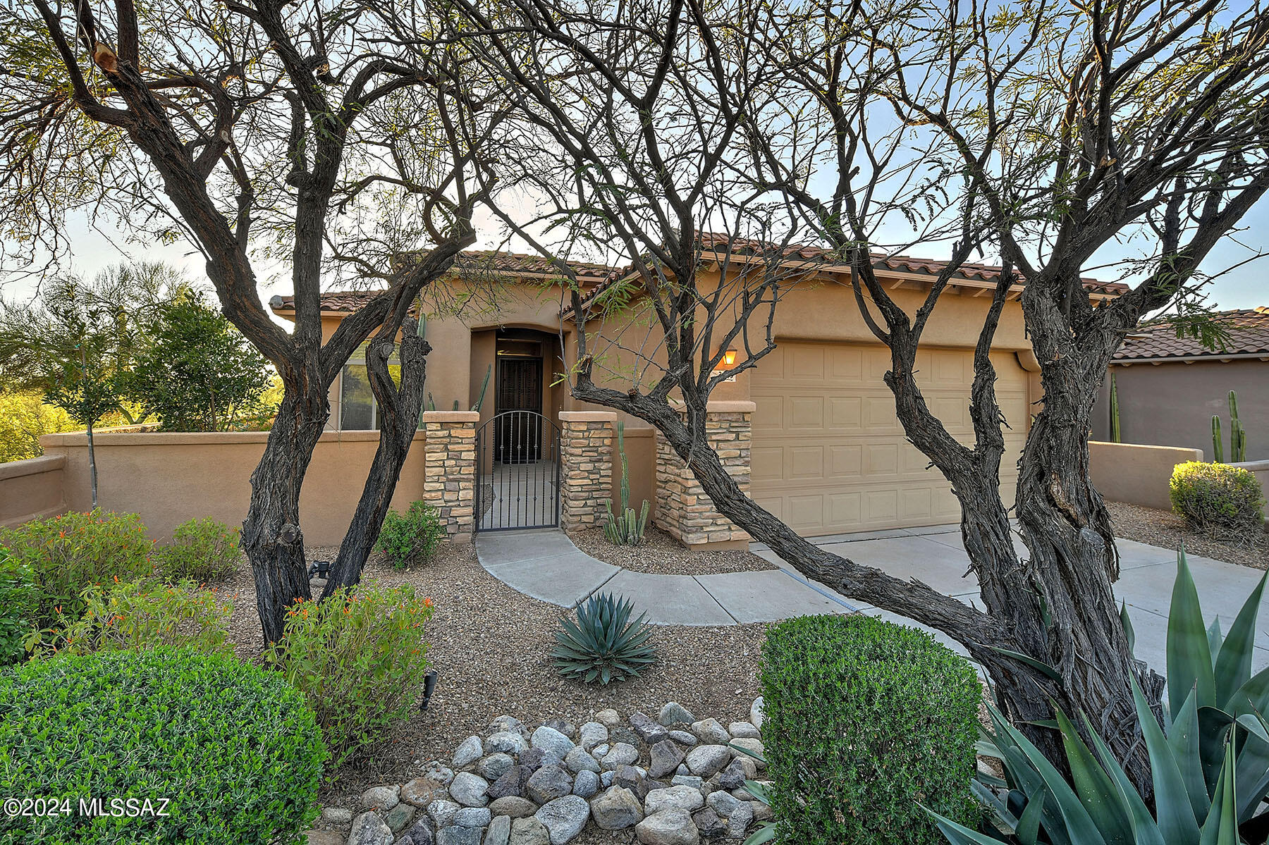 Nestled  in the beautiful Catalina Foothills, this property offers an unparalleled lifestyle w/ a breathtaking backdrop of the renowned La Paloma golf course. The beautifully landscaped front courtyard & dramatic rotunda entry sets the stage for what's inside.  The great room, boasting high ceilings, a stone fireplace, custom built entertainment center, & large picture window frames views that stretch for miles. Entertain with ease in the custom-designed  kitchen w/granite countertops, side-by-side refrigerator & wine cooler, gas cooktop, and cozy breakfast area. With over 2000 sq, ft., this residence offers ample space for both relaxation and entertaining. Featuring 3 BR's and 3 BA's, including a sumptuous primary suite, each space has been meticulously designed to maximize comfort.f Step outside to the fabulous backyard oasis, complete with mature landscaping, a covered patio, flagstone accents, and breathtaking views.  Ideally situated just moments away from upscale dining,  shopping, the La Paloma golf courses, and cultural attractions, this property offers the perfect balance of seclusion and convenience.