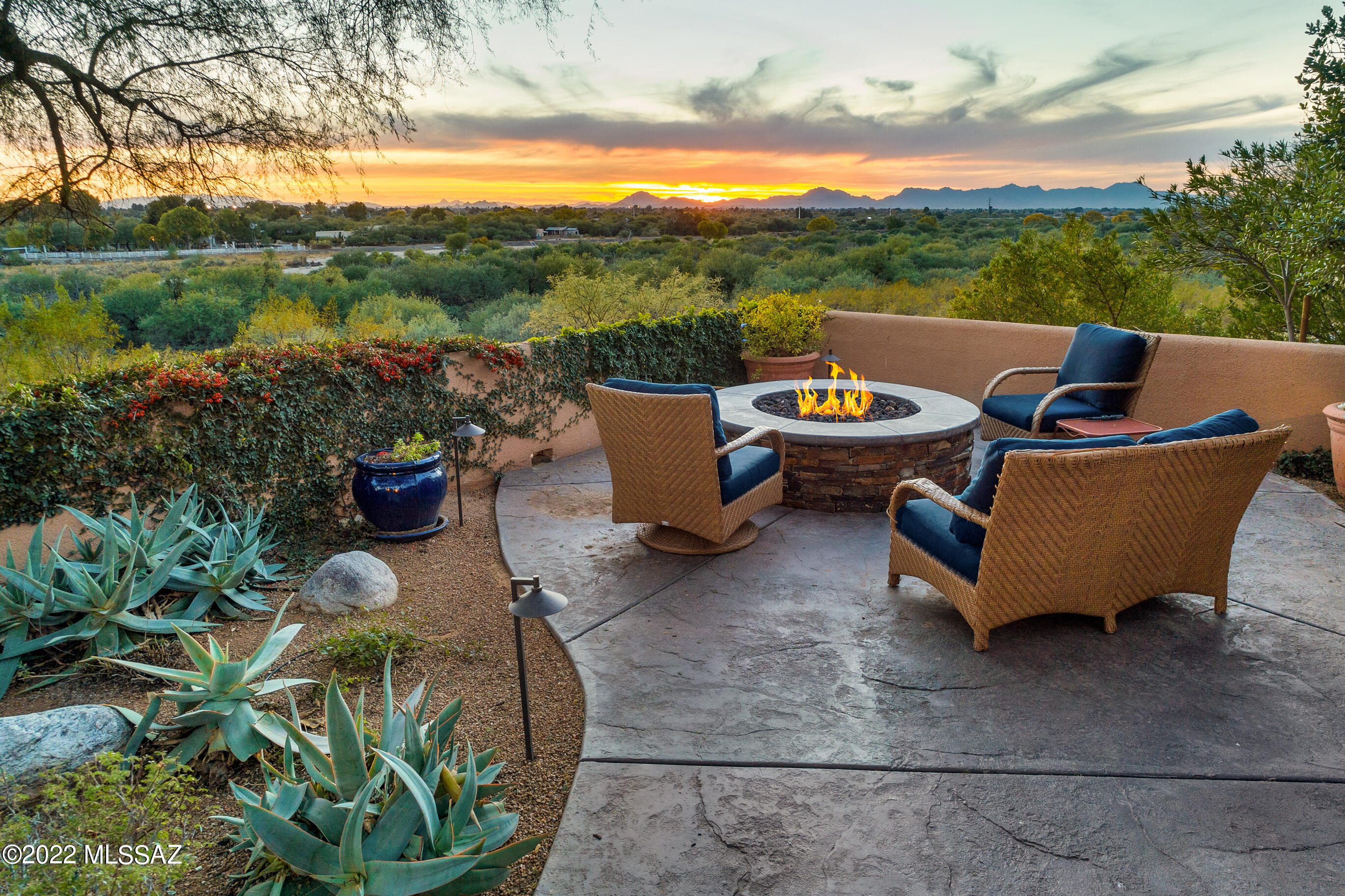 Private, sanctuary-style luxury residence w/ unobstructed, panoramic views of sunsets, city lights, natural desert & the Tucson Country Club golf course . Convenient foothills location  near Whole Foods & the Riverwalk. This one-of-a-kind lock & leave townhome is completely renovated w/ the highest quality materials & craftsmanship creating the ultimate Tucson getaway. Walled & gated courtyard provides privacy & a charming introduction. The impeccable interior space features hardwood & stone floors, a wood-beamed ceiling, & custom solid-core doors. Impressive gourmet kitchen w/ a center island, top-of-the-line SS Thermador appliances including 2 dishwashers, a six-burner range w/ double ovens, &  hood-vent. Exquisite kitchen w/ custom cabinetry & leather granite counters & backsplash. Spacious great room w/ gas bee-hive fireplace & formal dining area. Bonus family room off of the great room w/ built-in TV, room for office space & walls of windows leads to an unrivaled, south-facing backyard w/ a magical mesquite tree w/ a high-canopy, lush landscaping, built-in gas fire pit, & a gate for direct access to the Rillito wash. This enchanting space provides views across the wash to Tucson Country Club Golf Course & the natural desert in between.  Full-size storage room located in the backyard. 3 bedrooms & 2 full baths including a magnificent primary suite w/ french doors to the back patio, a dream walk-in closet w/ custom built-ins found in much more expensive homes. Exquisite primary bath w/ dual sink vanity, separate tub & shower, custom fixtures, cabinets & counters. Oversized laundry room w/ storage & oversized 2-car garage w/ utility sink and built-in storage cabinets. Community pool.

Incredible location just minutes to Basis Charter School, Whole Foods, Orange Theory, Public Library, the Gregory School, Castlehill Country Day School and the River Walk Bike Path- a 133 mile bike loop connecting all across Tucson.

World-class golf resorts nearby include Ventana Canyon and La Paloma.  Exclusive golf and tennis clubs nearby include Skyline Country Club and Tucson Country Club.   

Located at the south-end of the foothills, this location is not far from the University of Arizona and downtown Tucson.