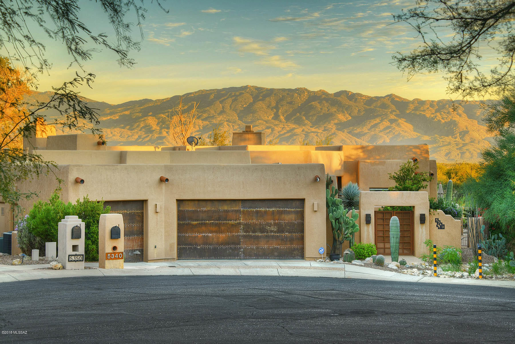Stunning custom home overlooking Az National Golf Course. Private cul-de-sac lot with incredible mountain vistas. Top of the line finishes including travertine flooring, Alder doors & coved ceilings. Great room with many picture windows and opens to gourmet kitchen featuring large island, Dacor appliances, warming drawer & 6 burner gas range. Luxurious master suite has cozy fireplace, jetted tub, walk-in closet. All guest bedrooms are en-suite. Fabulous media/game room or exercise room downstairs along with a 2nd master or guest suite. Over-sized 3 car garage with extra storage. Entertain on the wrap around patio while splashing in the pool & spa, or practice your short game on the putting green and don't forget about the sun deck where you can enjoy panoramic views!