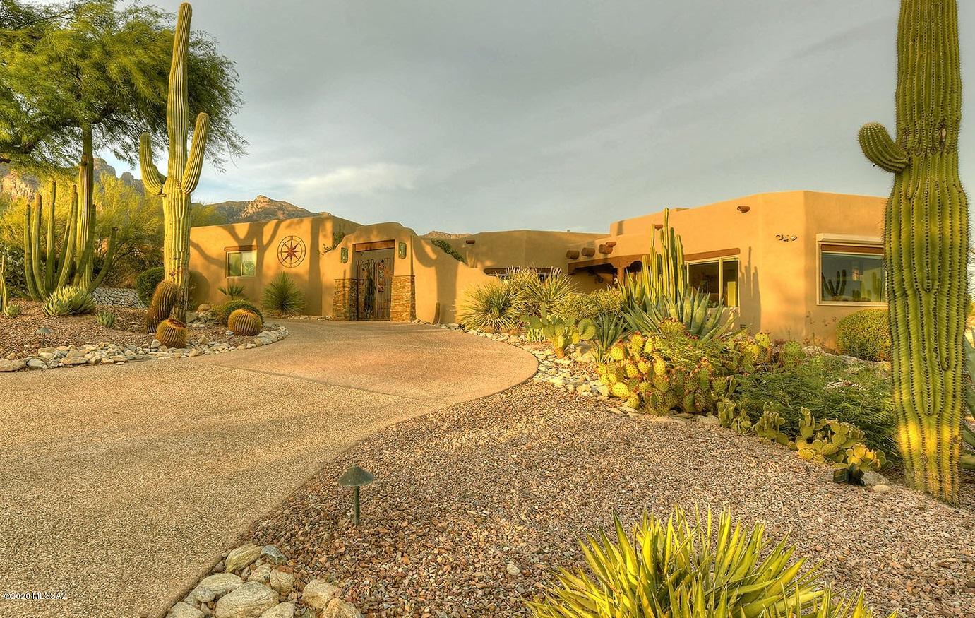 Amazing Panoramic City and Mountain views adorn this ridgetop home set on a quiet cul de sac in the Sin Vacas Gated Community. Conveniently located a mile north of La Encantada Mall AND is in the Catalina Foothills School District! This southwestern style home features elegant soaring 9-12-foot ceilings throughout, accentuated with gorgeous wood viga beams, and multiple outdoor sitting areas.  Well maintained w/many new upgrades including remodeled kitchen, baths, landscape irrigation, HVAC, New alder wood interior doors, Newly painted in and out...and more. Split bedroom plan offers privacy to the master suite and a 4th bedroom on the lower level with a separate bath and exterior entrance. Come and be enchanted by the expansive city lights and the poolside mountain views. Owner is Agent. all surrounded by the architecturally designed landscape for a year-round serene vacation feel. 
(Bedroom # 2 currently used as an office, Bedroom #4 currently used as an exercise/yoga and music room)