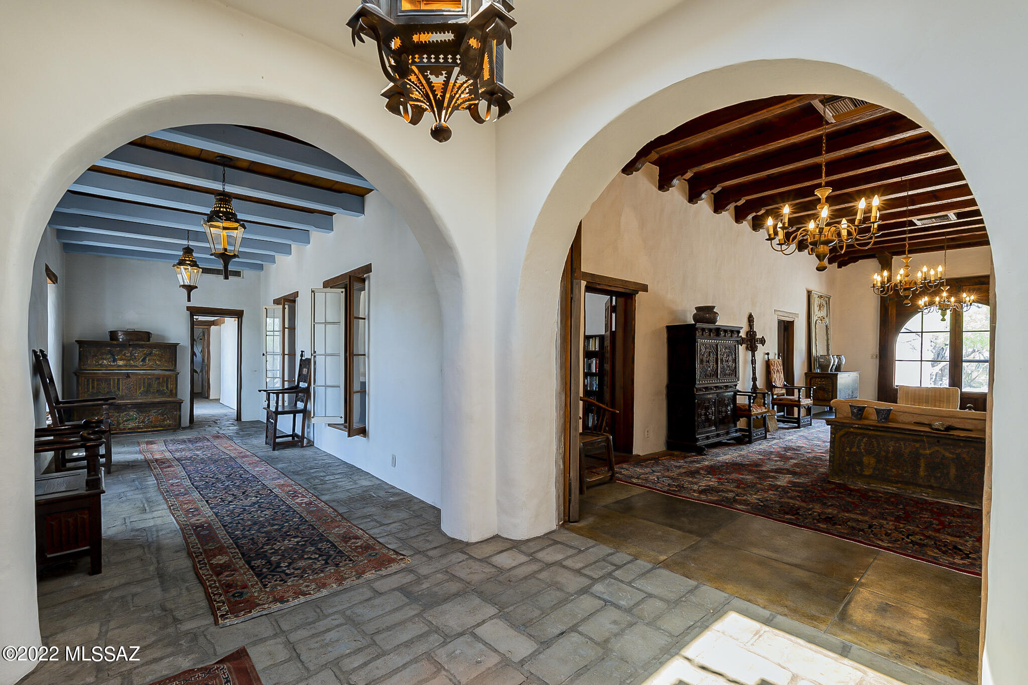 One of Tucson's most significant and historic properties is now on the market. This amazing Adobe Hacienda style home, built as the US Calvary's trading post in 1873, has had only 3 previous owners. Enter through the hand carved wooden arched entryway to the zaguan or grand living room. Four generous bedrooms (2 w/sleeping lofts) flow seamlessly from the living room. The master bedroom has THE most breathtaking view of the 60 ft long, stone edged pool! At the end of the pool the unobstructed view continues to the majestic Catalina mountains. The master bedroom's ensuite bathroom features hand glazed tiled double sink vanity, double WC, walk in shower, tiled tub w/vintage, carved Jaguar head waterfall spout, and a spacious walk in closet. Traditional double windowed 9 ft x 54 ft gallery leads to the massive wood beam ceilinged formal dining room with a wood burning fireplace & sliding doors to a stone lined courtyard, perfect for alfresco dining. The spacious, tiled countertop kitchen features a working, vintage Wolf stove w/extra griddle space. A mature, thriving Mesquite tree is growing right in the middle of the great "pantry" which also has a chilly 4 ft x 8 ft walk-in refrigerator with plentiful wine storage. The extensive fifth bedroom is just through a carved wooden door, off of the breakfast nook in the kitchen. This individual area has it's own entry from the outside & features a bedroom, complete with fireplace, 2 closets in the bathroom, and 2 living areas, both with fireplaces. This suite has wonderful views of the rear of the property and the sparkling water feature/pond. A free standing guesthouse, with private entrance to the outside features one bedroom, complete kitchen & bath & living room w/fireplace. There's a private, walled courtyard off the living room. This charming, adobe bungalow casita would be ideal for in-laws, friends, or, possible, rental income. Property has an enclose 2 car garage, 3 car carport, a 2 room pool house for ample storage, a separate pump room for pool equipment, and another outbuilding for whatever you require. There are too many unique elements of this property to list! Step back in time with this fascinating property's 149 year history, while enjoying the comforts of today. Recent updates include new A/C units, 
buildings roof coating (with warranty), landscape has been trimmed, 2 new septic tanks installed (with permits & warranties), some updated plumbing and property has been connected to city water. Property is being sold AS IS and is ready for you to add the finishing touches on this once of a lifetime opportunity to live in one of the oldest haciendas in the Southwest. The Old Fort Lowell area is on the Historic Register, where character of the area will not change. Some if the original furniture pieces can be available with acceptable offer.