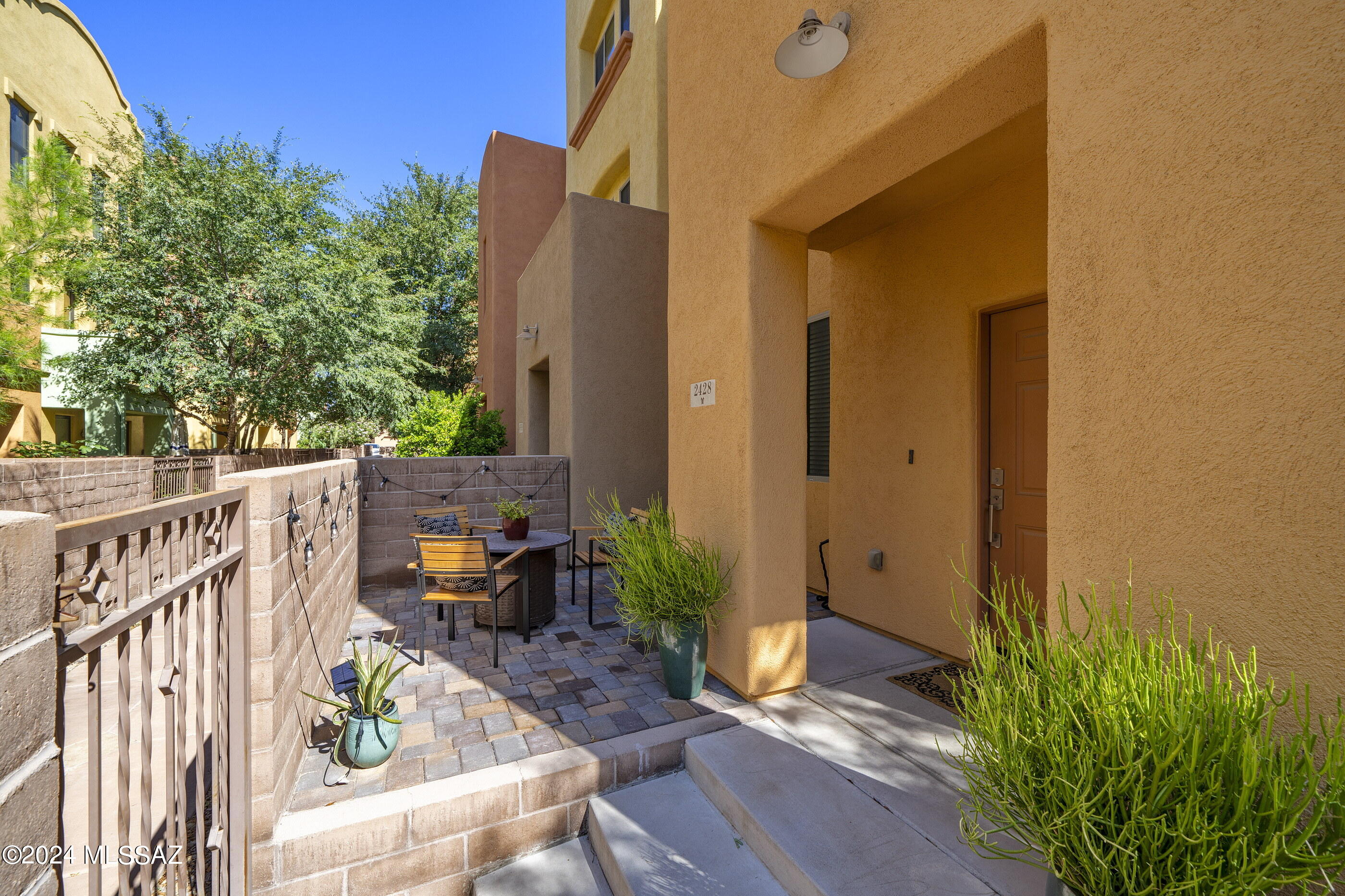 2 Story end unit in River Walk!  Conveniently located by the Loop walking and bike path, St Phillips Plaza, retail and dining.  This well maintained property is ready for you to call home!  Gated front entry with sitting area and paver patio. Great room with tile flooring, rich dark wood kitchen cabinets, granite countertops and stainless appliances. Kitchen island has eat at bar. LG Stove, microwave, refrigerator, washer and dryer all less than 2 years old.   2024 New AC unit!  Primary bedroom is spacious and filled with natural light and luxury vinyl plank flooring.  Massive walk in closet with built ins.  Wonderful balcony with expansive mountain views.  2 car garage.  Gated community has pool, spa, fitness and community center