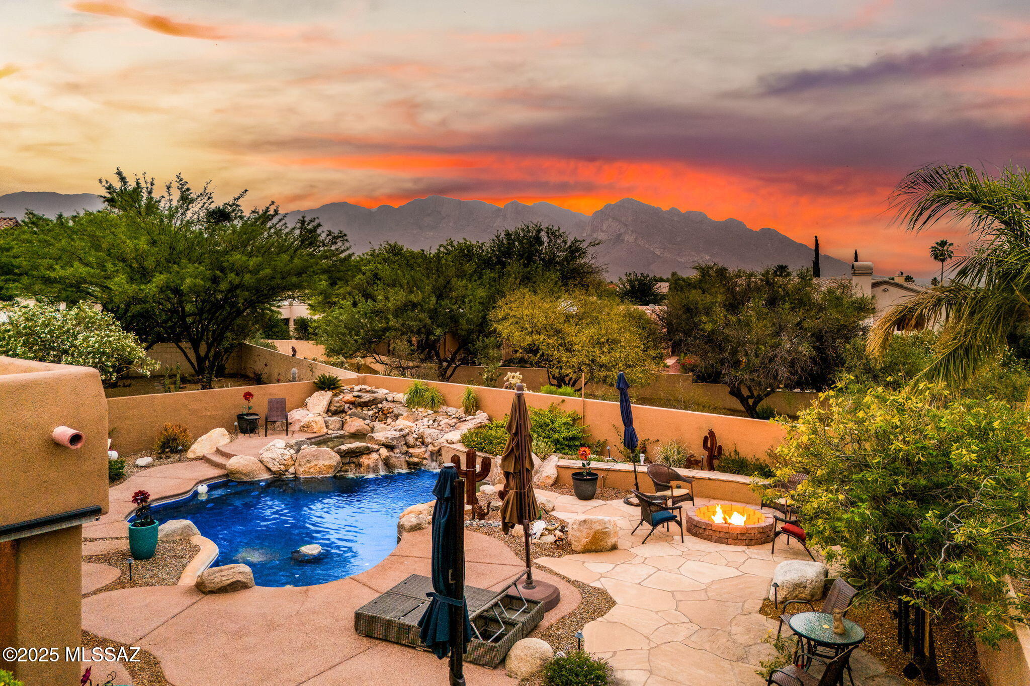 This one is a showstopper, friends. Welcome to 1943 W Canada Hills Drive, right in the heart of Oro Valley's sought-after Canada Hills neighborhood. If you've been dreaming of desert living with resort vibes—this is it.

Let's talk backyard goals. You've got your own private retreat with a PebbleTec lagoon-style pool, spa, and a rock waterfall that will make you feel like you're on vacation every day. Plus, no nosy neighbors behind you—just those drop-dead gorgeous Pusch Ridge views. Firepit, built-in BBQ, party-ready flagstone patio... yep, we checked all the boxes. Inside, it's just as dreamy. The kitchen is updated with granite, stainless, and an extended bar that says, "Come sit, stay a while." The cozy family room brings all the feels with a gas fireplace perfect for those cooler desert nights. The primary suite? Oh, she's extra. Patio access, a closet that's got room for it all (plus built-ins), and a spa-like bathroom to soak away the day.

And the updates? Let's just say the big stuff is already done for you. New roof, fresh exterior paint, smart pool controls (hello, heated spa from your phone), and a full Ring security system. Plus, no poly plumbing hereit's already been updated, so you can move in worry-free.

This is the one that makes you say, "Where do I sign?" Let's get you in to see it.
